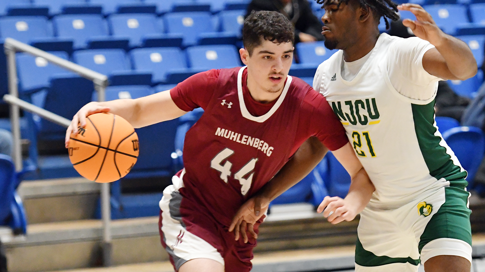 a basketball player in a red jersey driving on a player in a white jersey