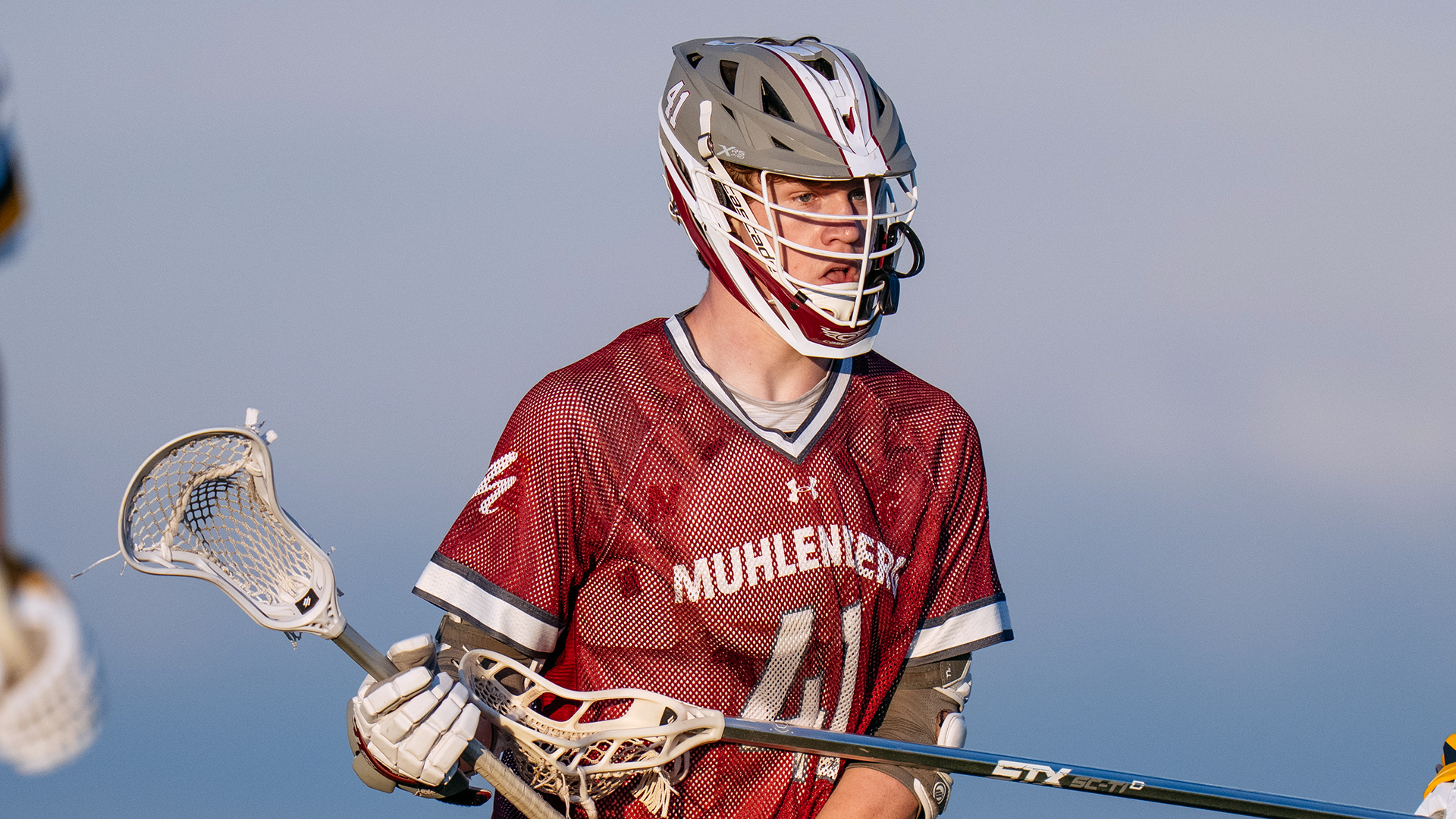 a lacrosse player wearing a red jersey with the number 41