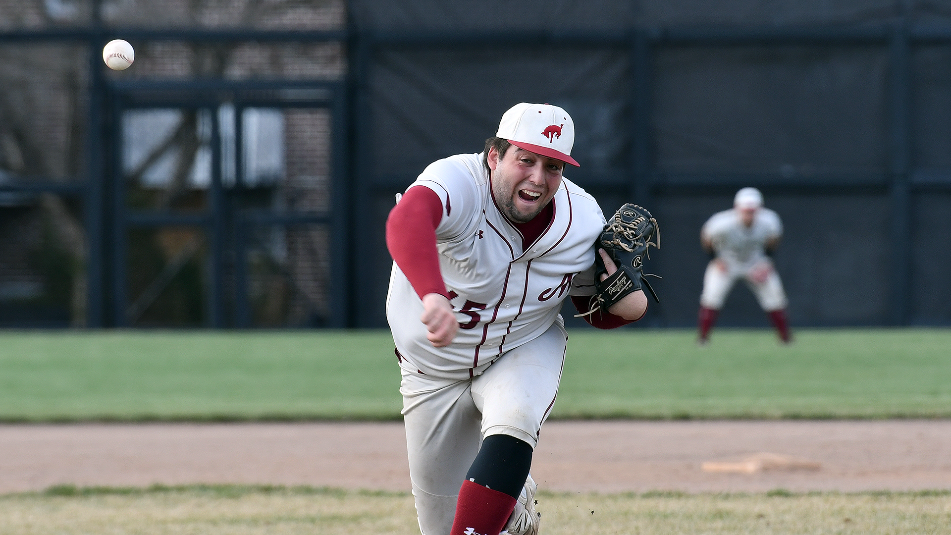 a baseball pitcher in a white uniform and white hat delivering a pitch