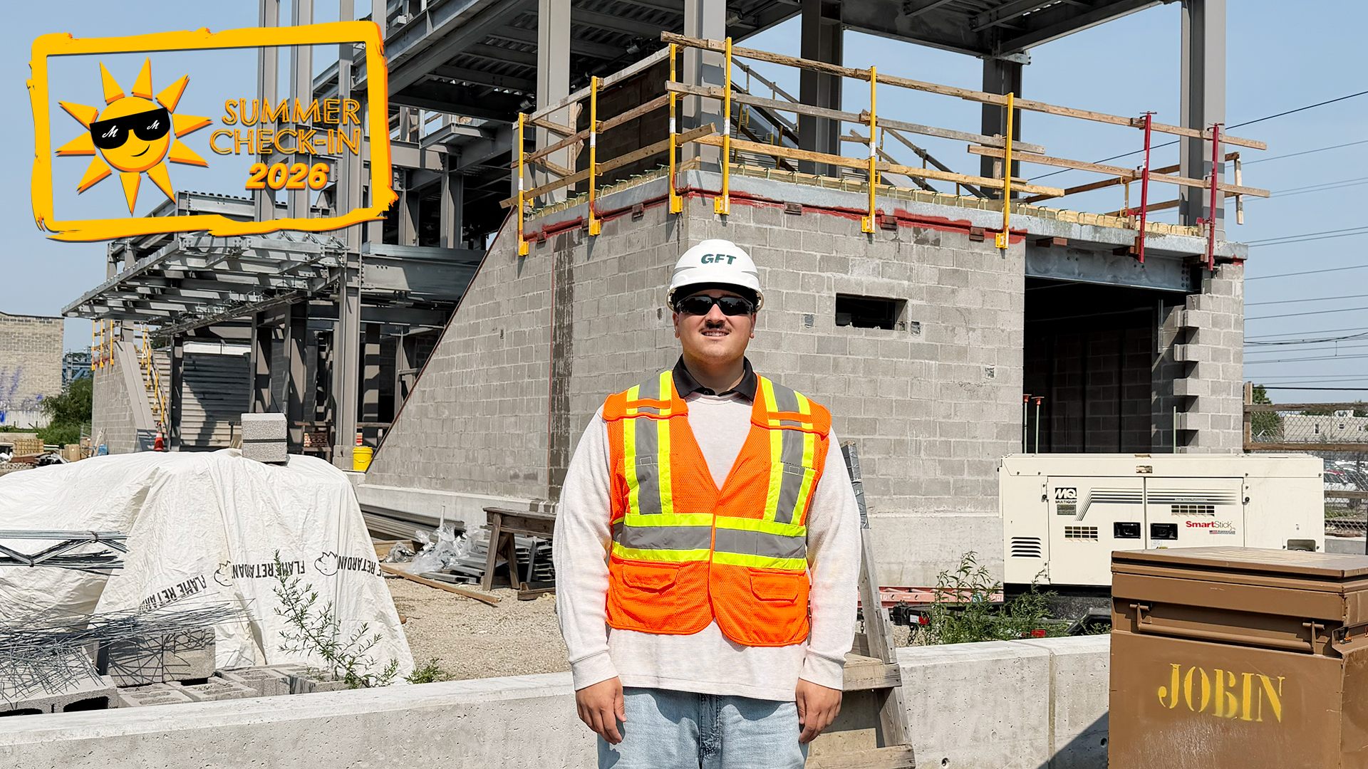 a young man in a white hard hat and construction vest standing in front of a new construction site