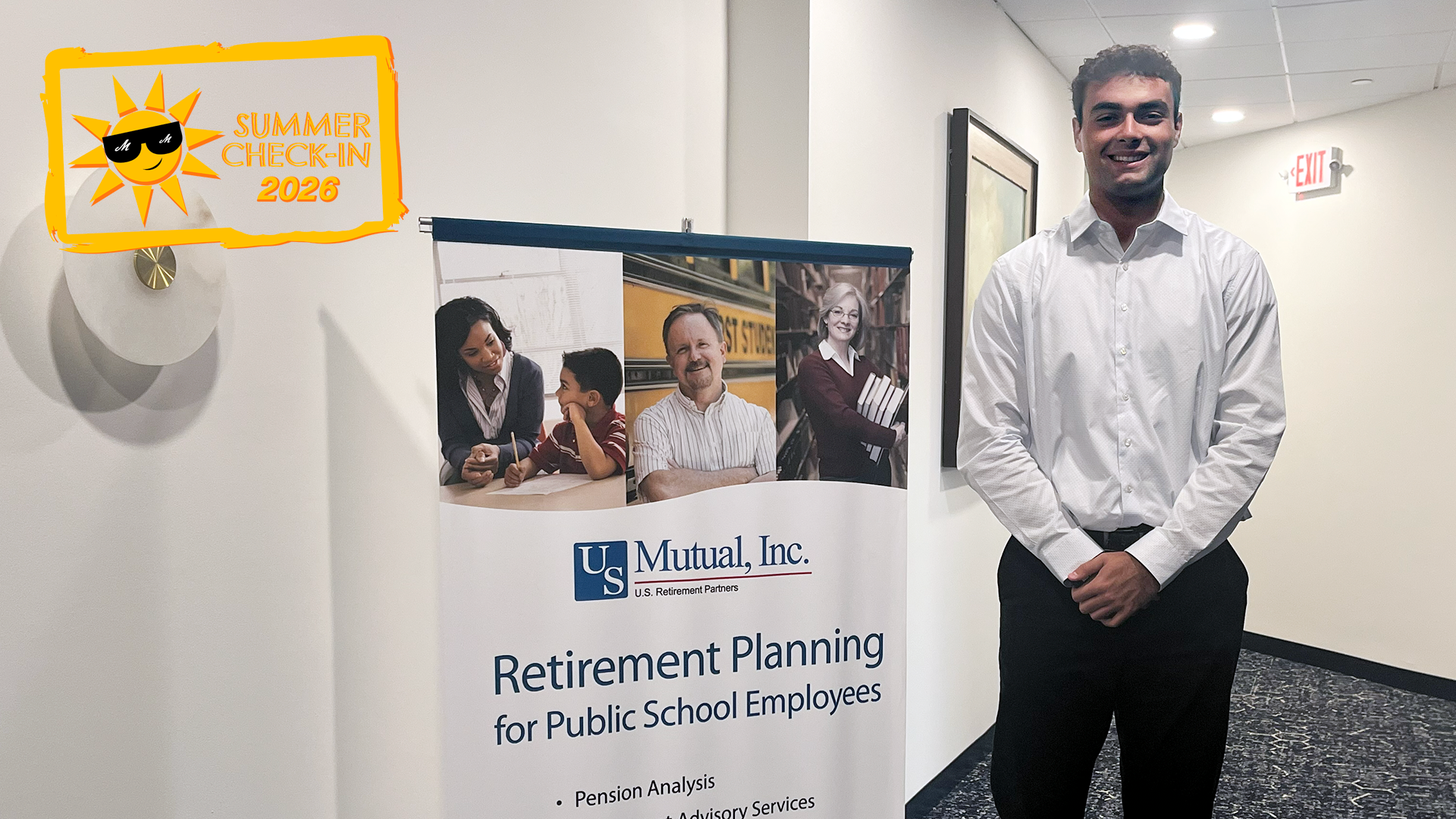 a man in a white dress shirt and black slacks standing in front of a U.S. Mutual poster
