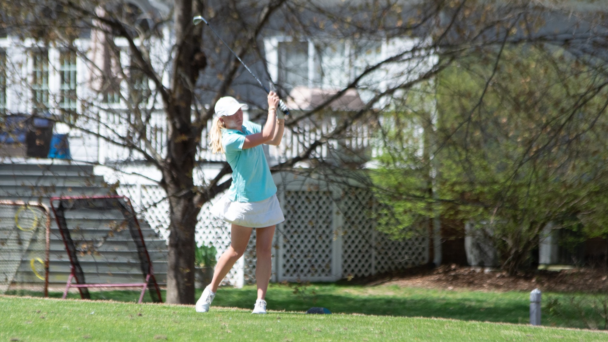 Jenna Rutledge back swing in emerald shirt