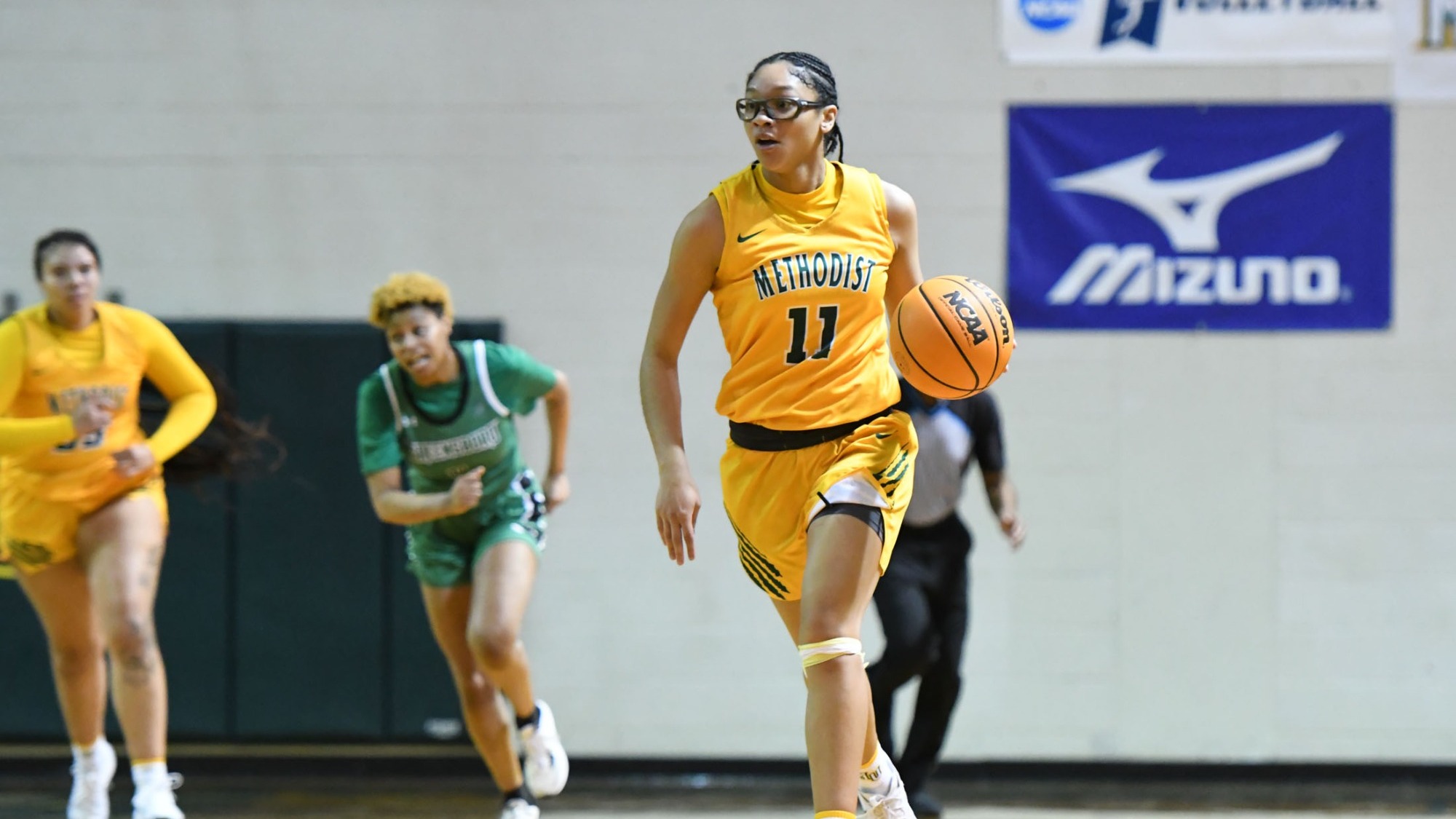 Kayleen Grullon dribbling in gold