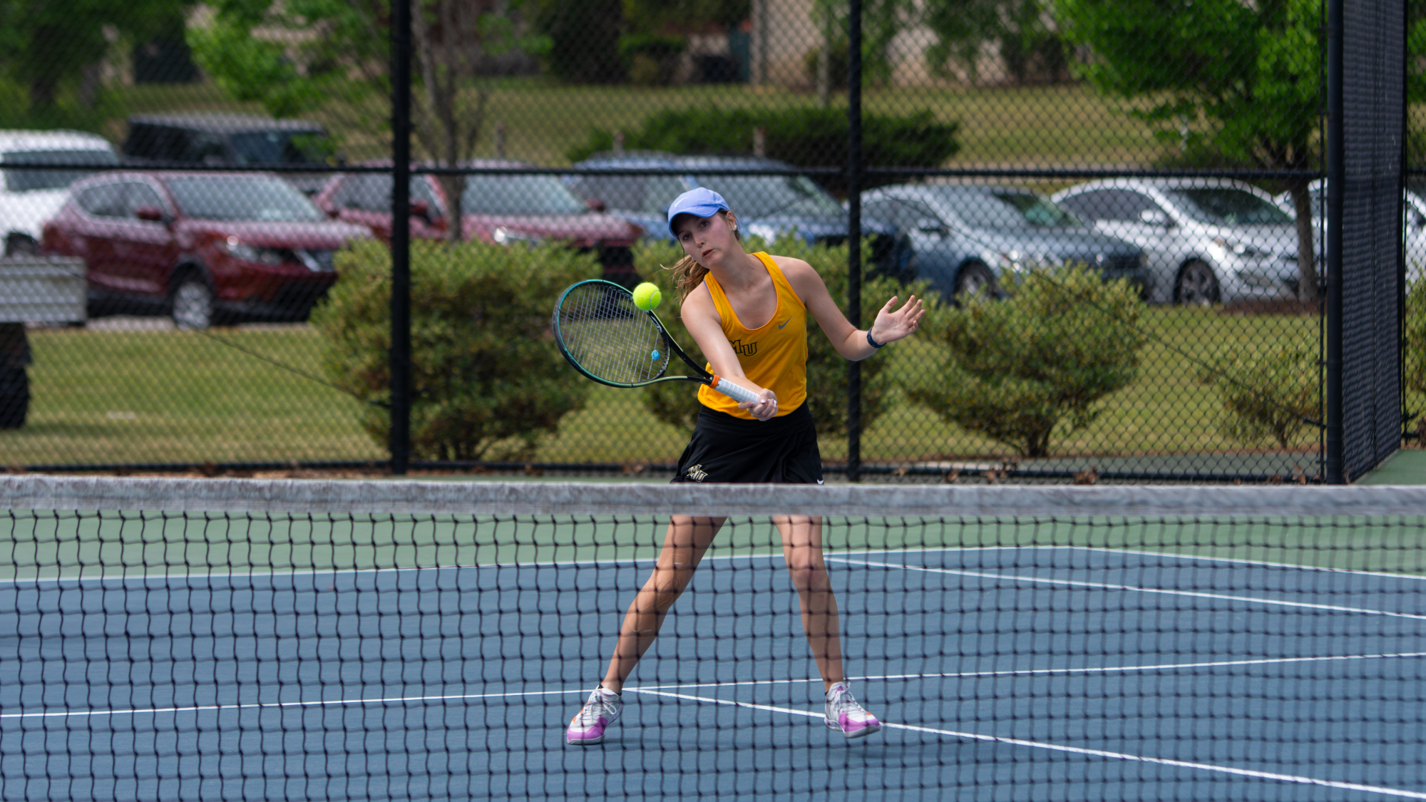 Caitlin Tihanovich returning ball close to net