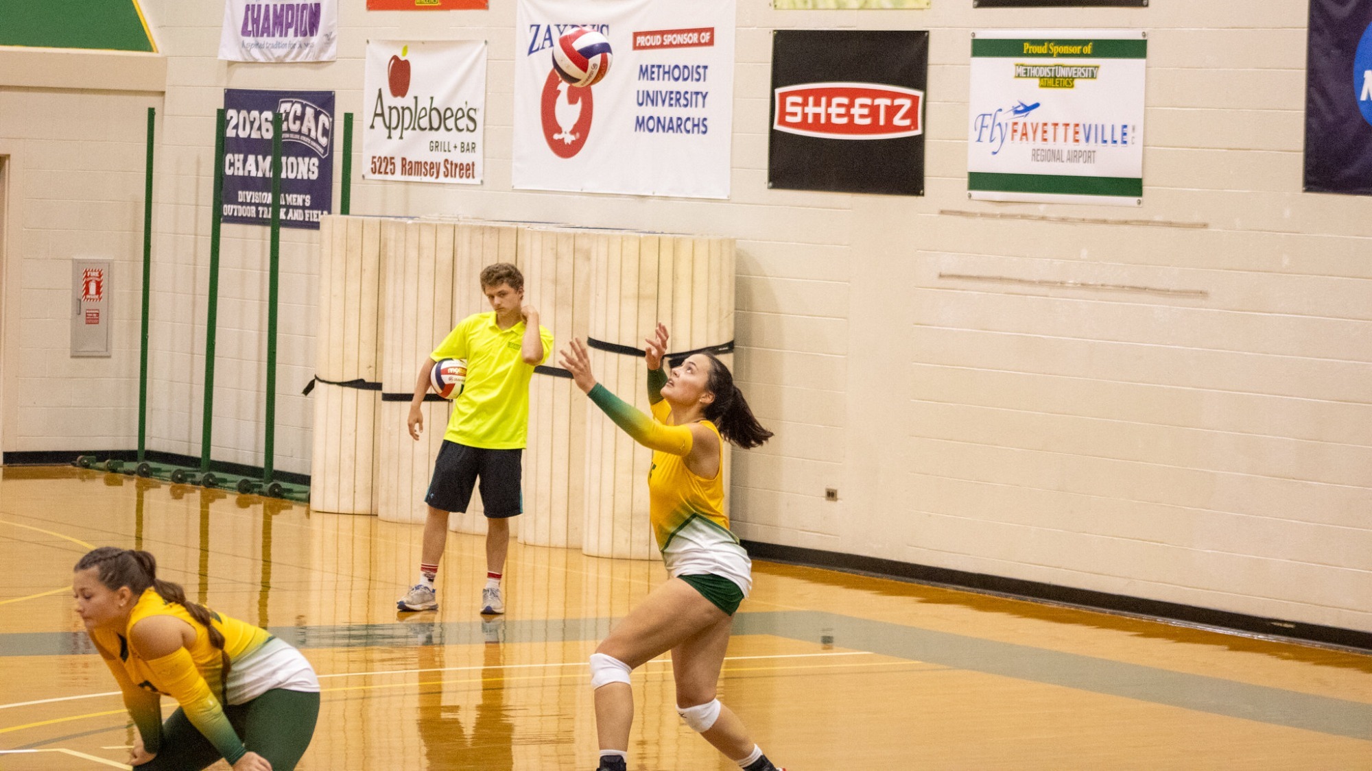 Savannah Hovander serving during the Mary Baldwin match at home