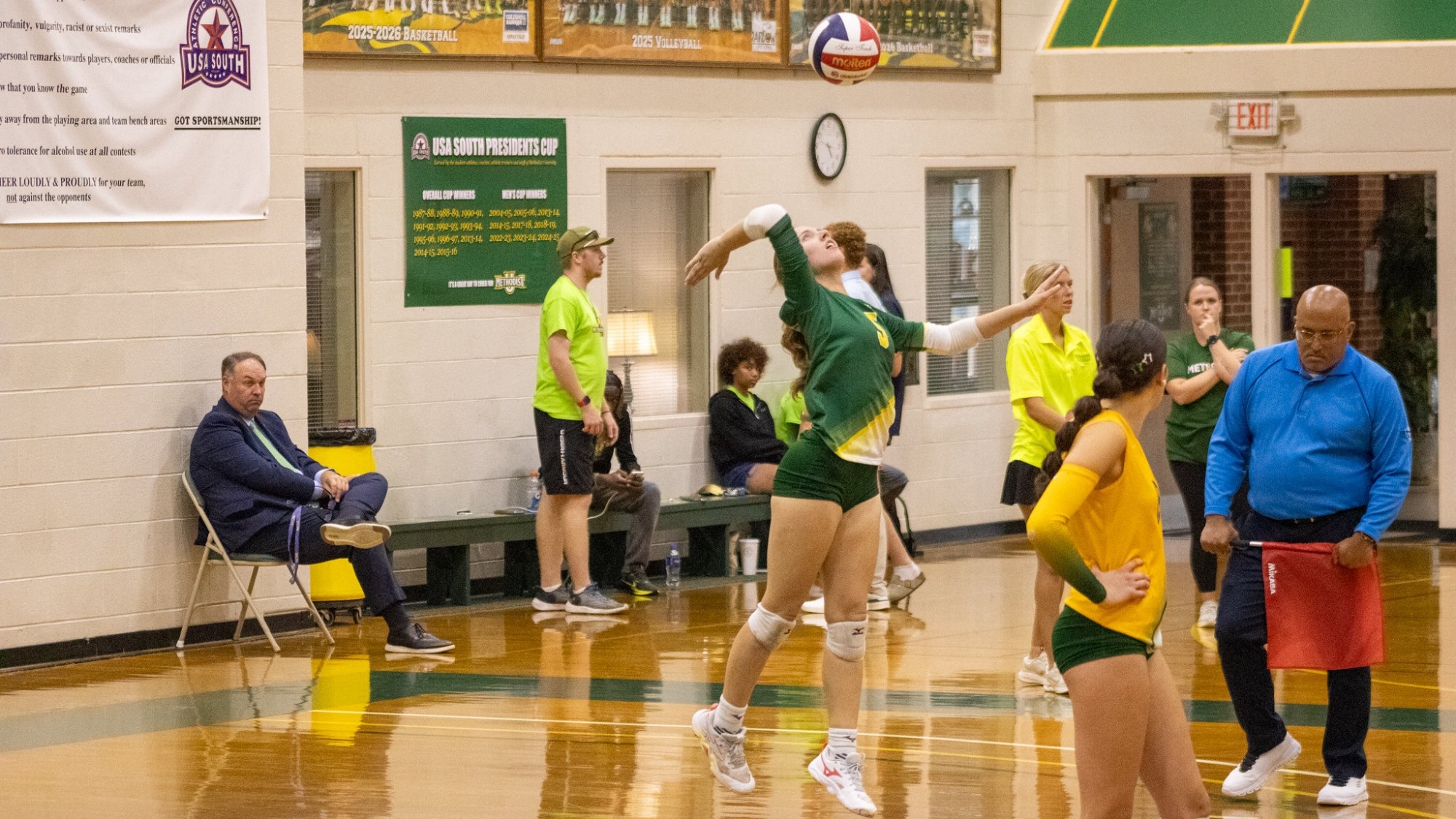 Ashley Farman serving against Mary Baldwin at home