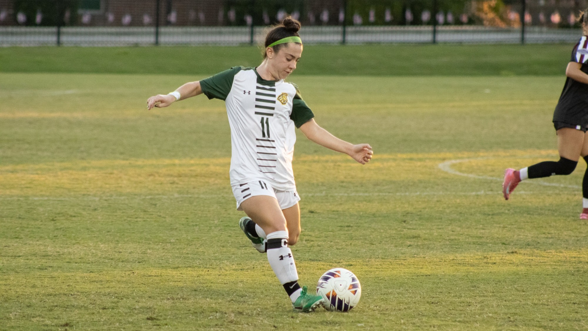 Emily Hoyt going to kick the ball at home