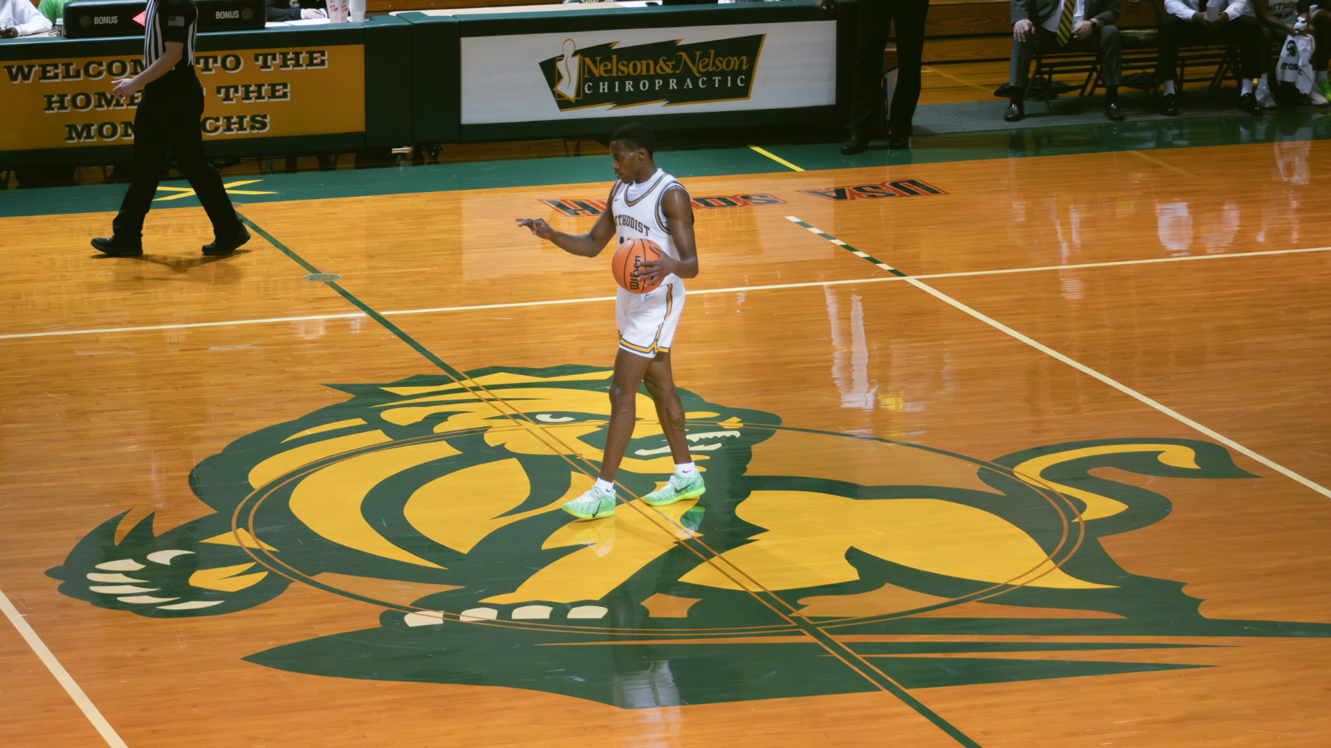 O'Montae Daniels at half court Monarch logo