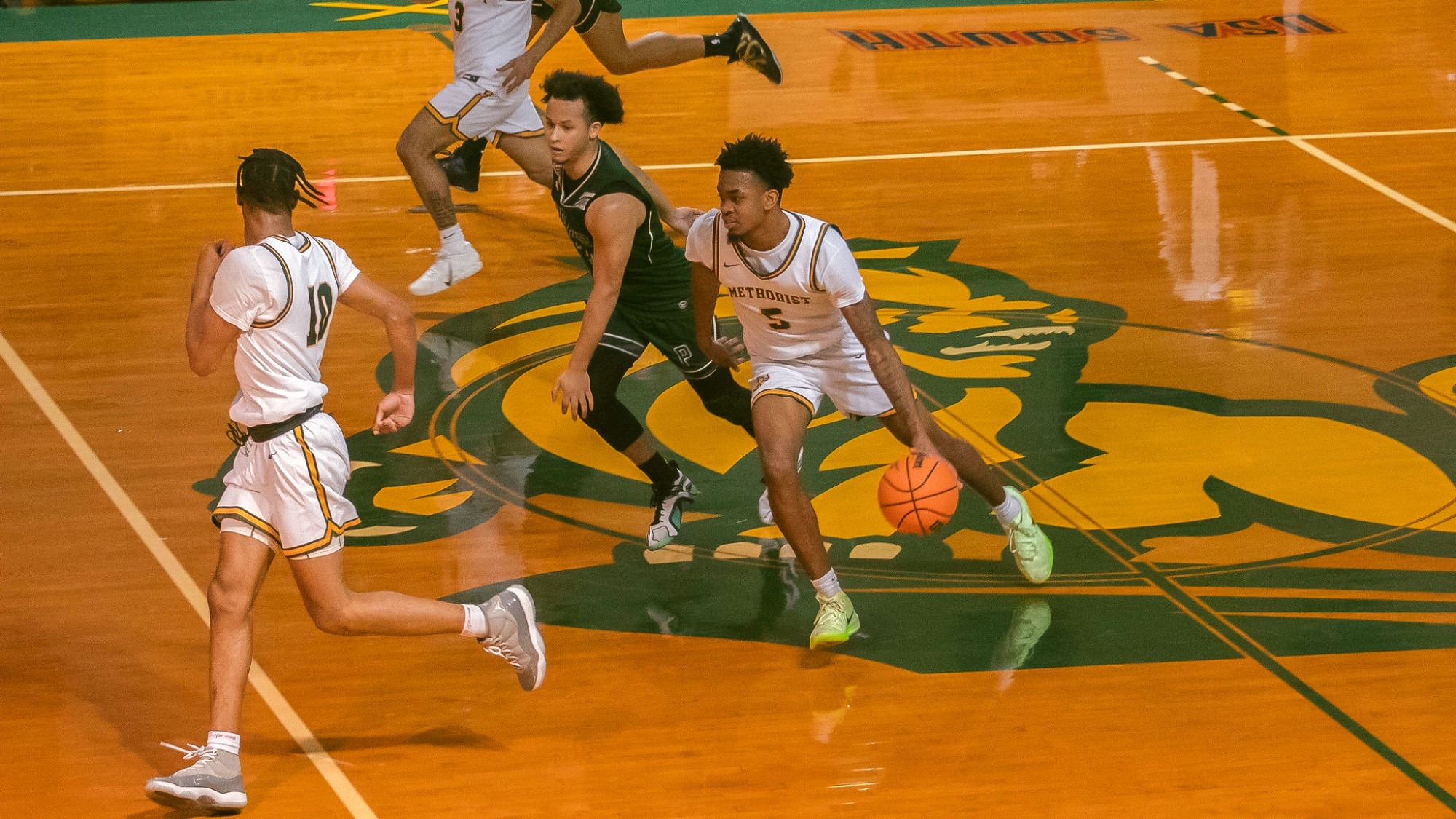 KJ Brooks being guarded while bring the ball up the court