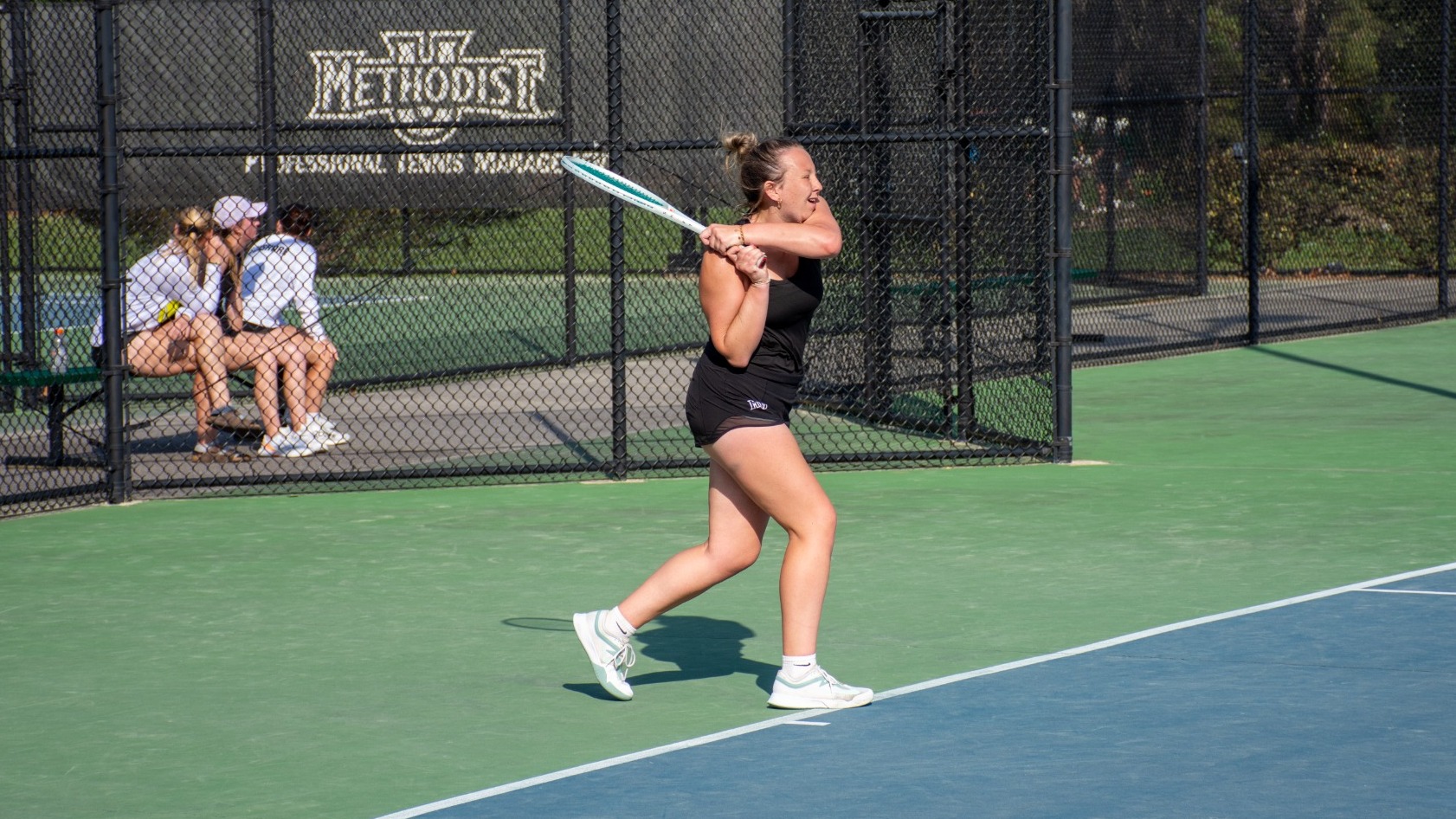 Katie Sechrist following through her swing
