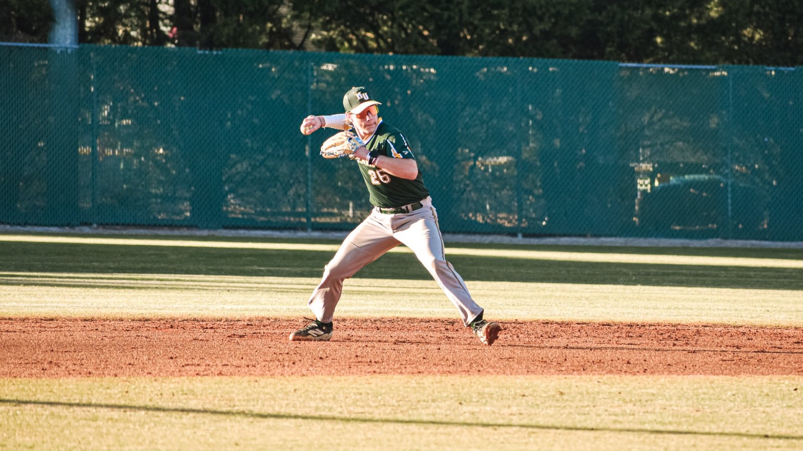 Kade Bell throwing to first base