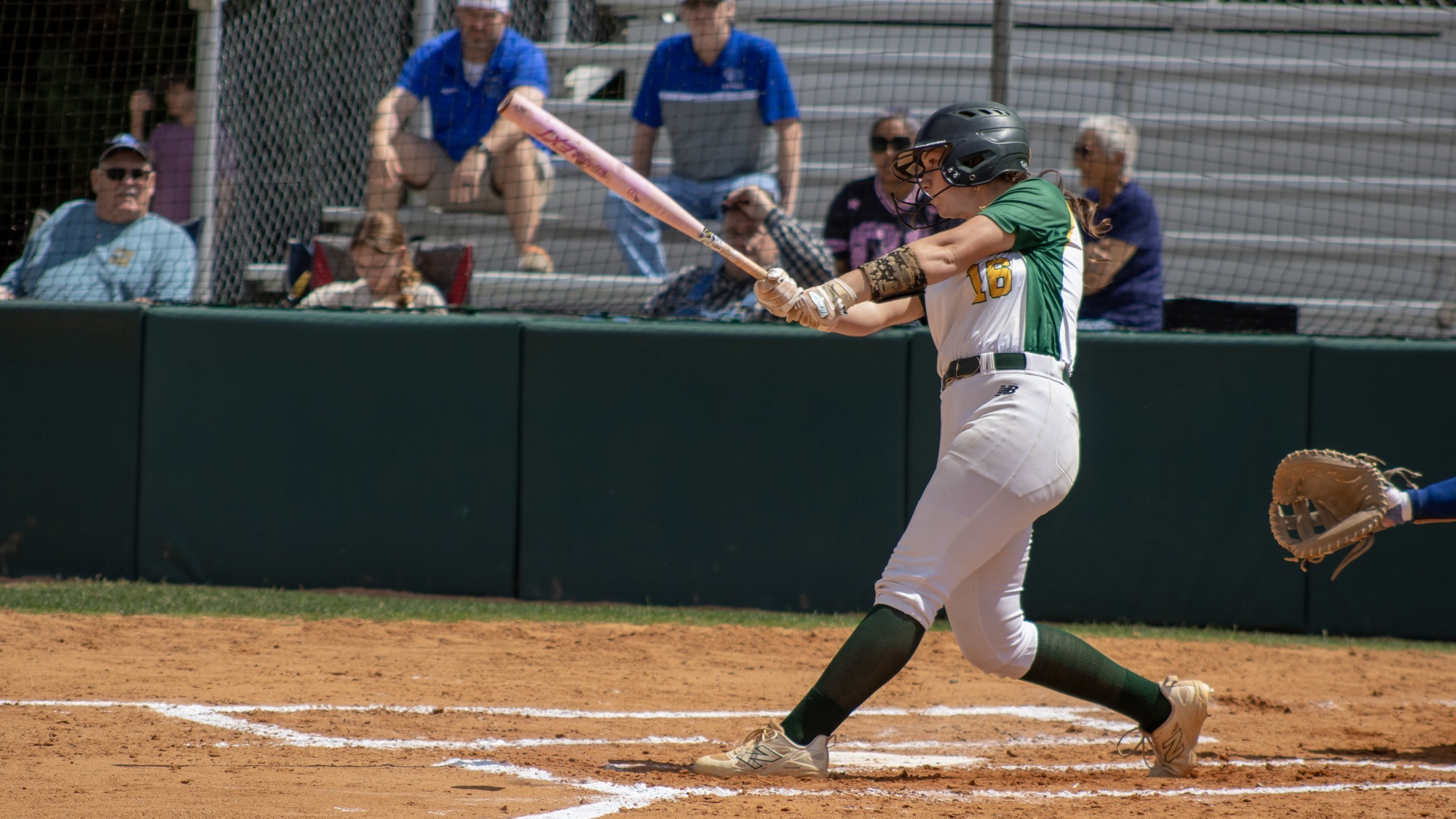 Rachel Lawson swinging her bat at home