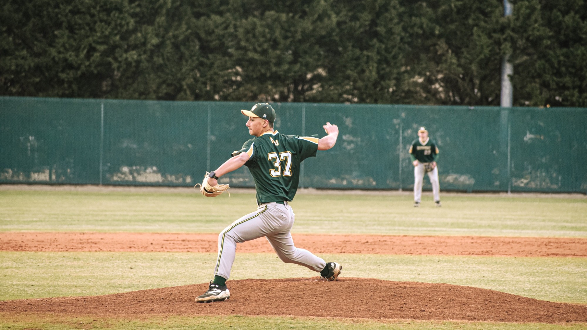 Bryce Mauger pitching in green jersey scrimmage
