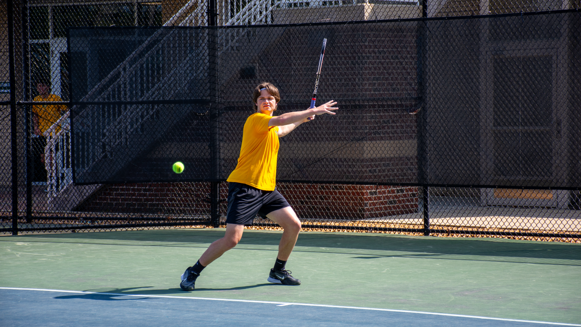 Matthew Hurley gold shirt forehand