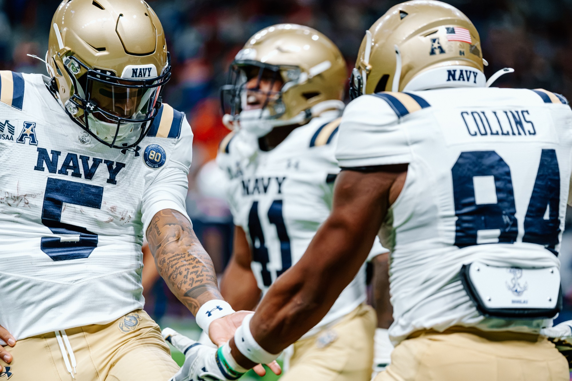 Jordan Collins and Braxton Woodson celebrate in the end zone in San Antonio