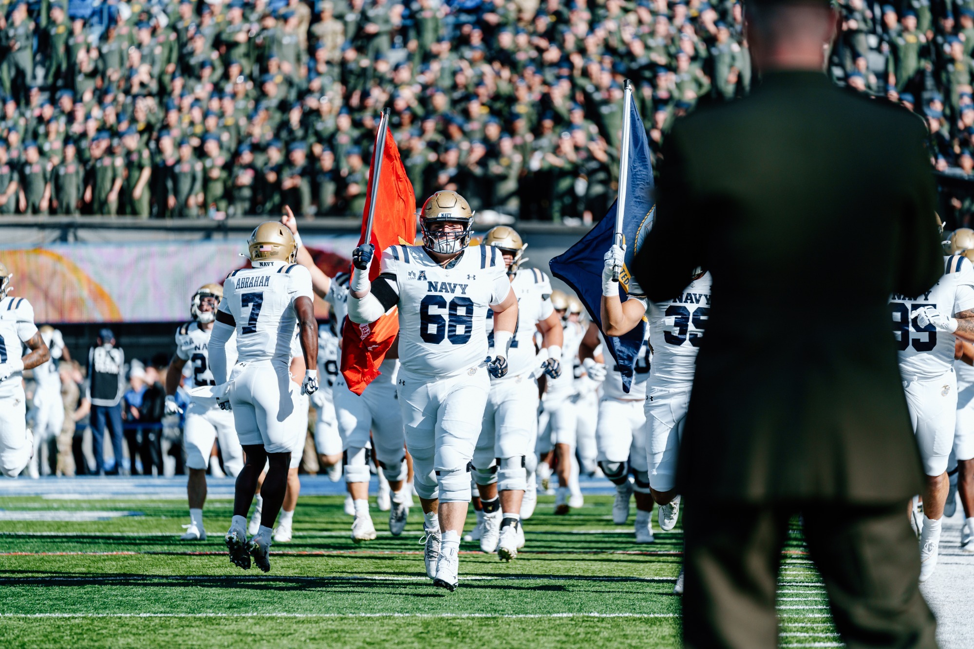 Hoke Smith II carries the Marine Corps flag out before the Air Force game