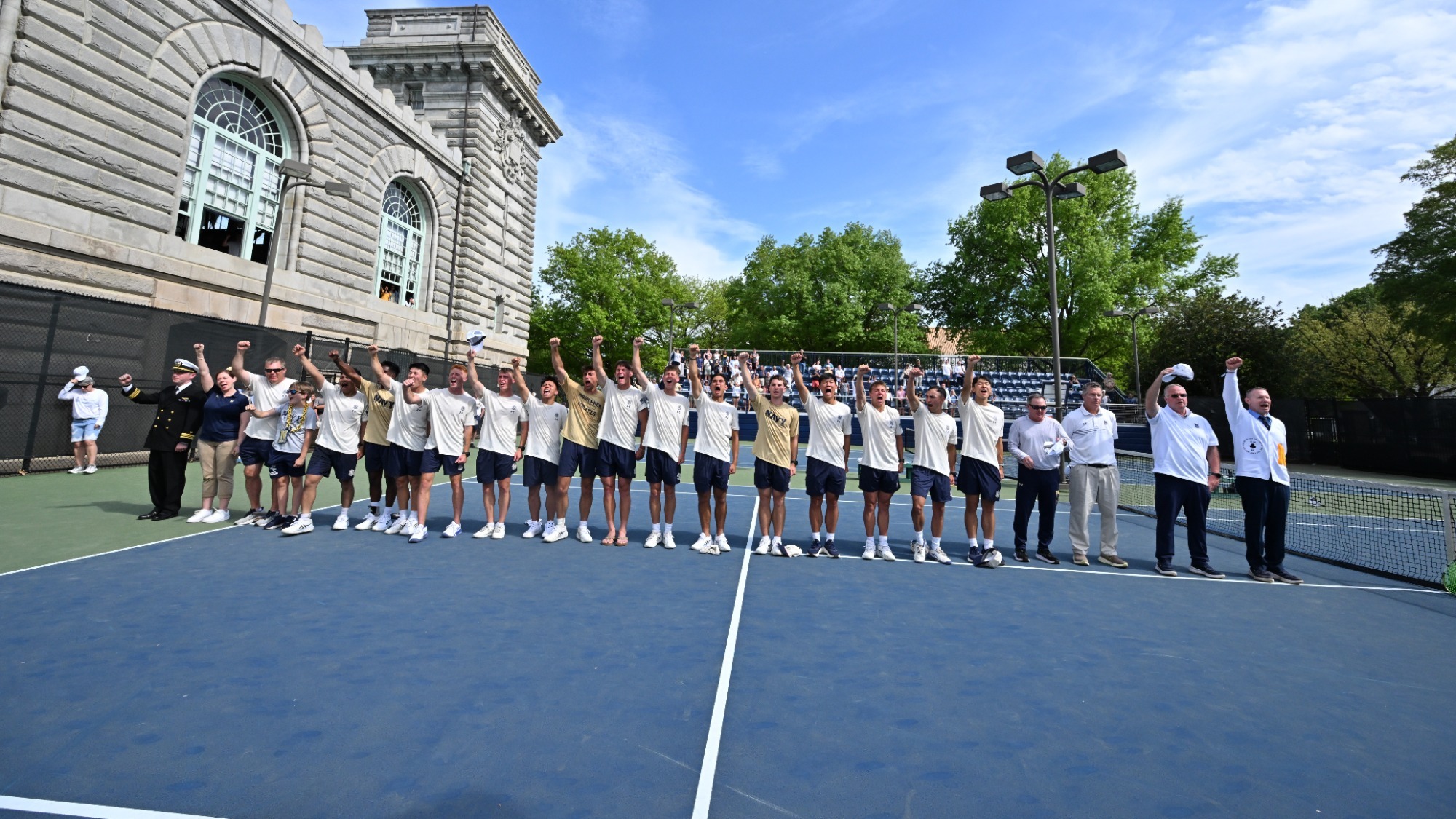Navy celebrates the victory over Army in men's tennis