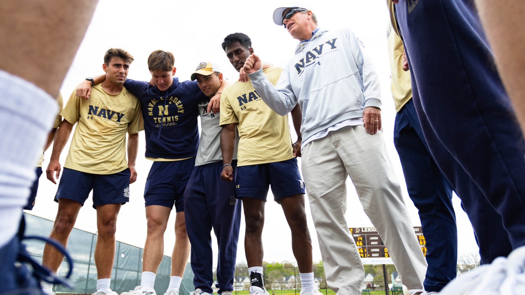 Navy men's tennis huddle Chris Garner