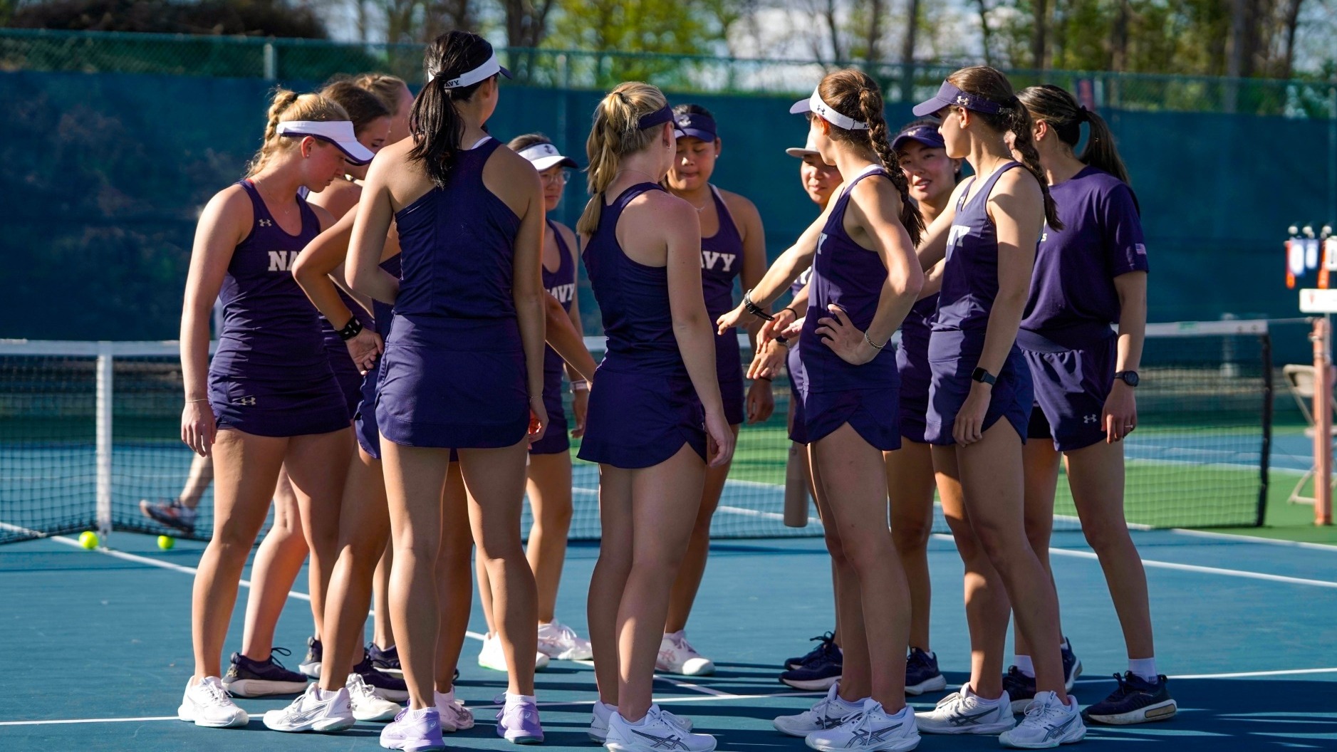 Navy forms a team huddle prior to the 2026 Patriot League Women's Tennis Quarterfinals against Colgate on April 17 in Lewisburg, Pa.