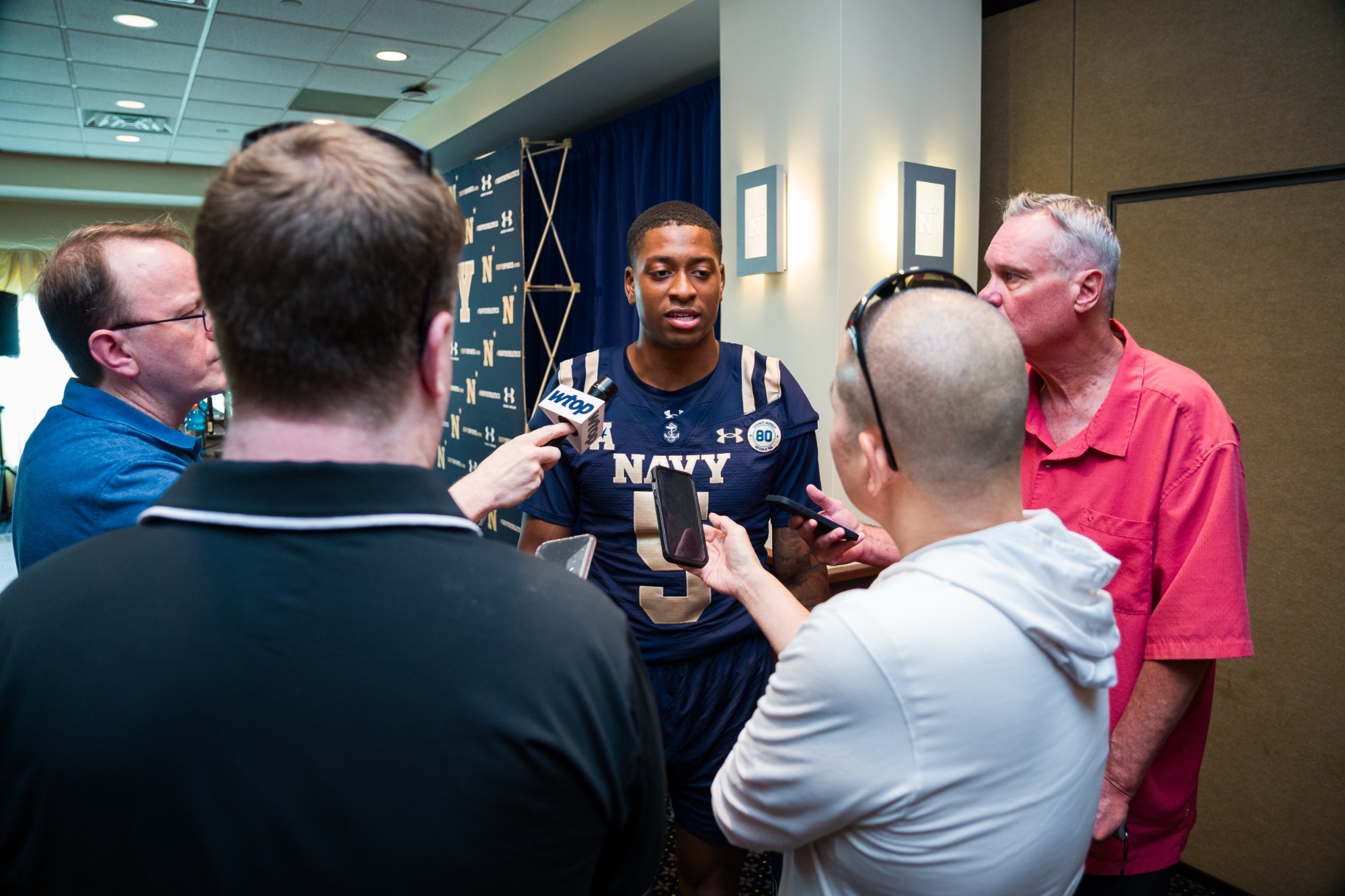 Navy Quarterback Braxton Woodson talks to the media