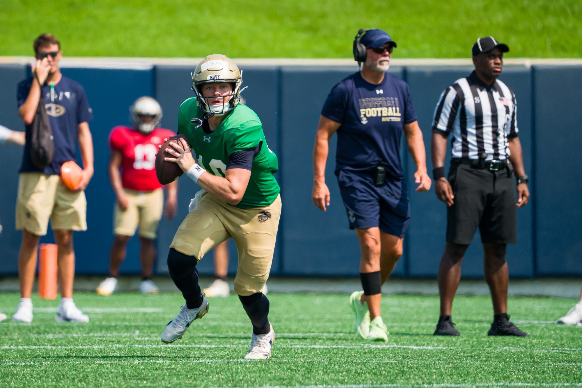 Sophomore quarterback Ryan Brass rolls out to pass at a scrimmage