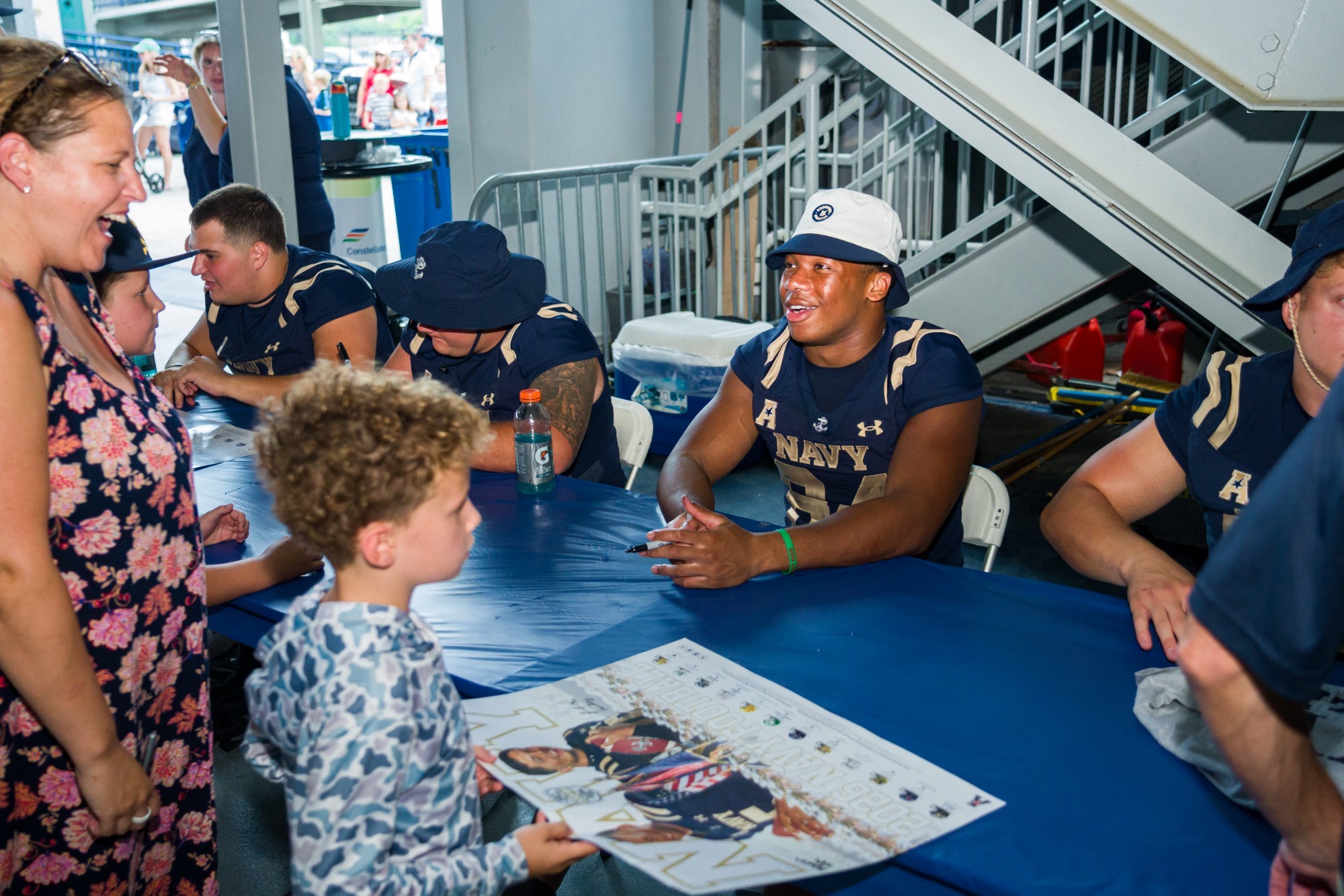 Jordan Collins signs an autograph for a young fan