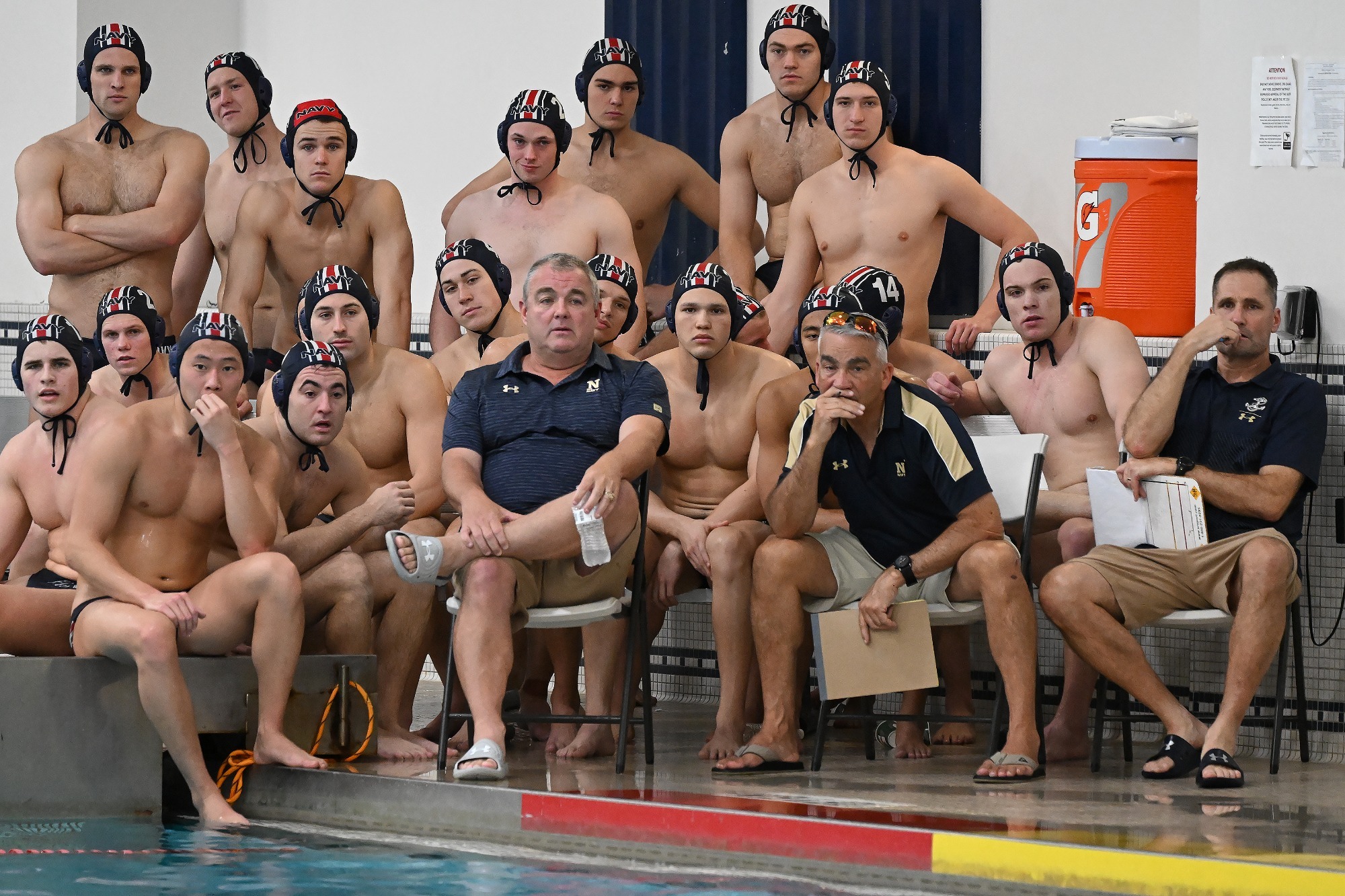 Navy head water polo coach Luis Nicolao and his team
