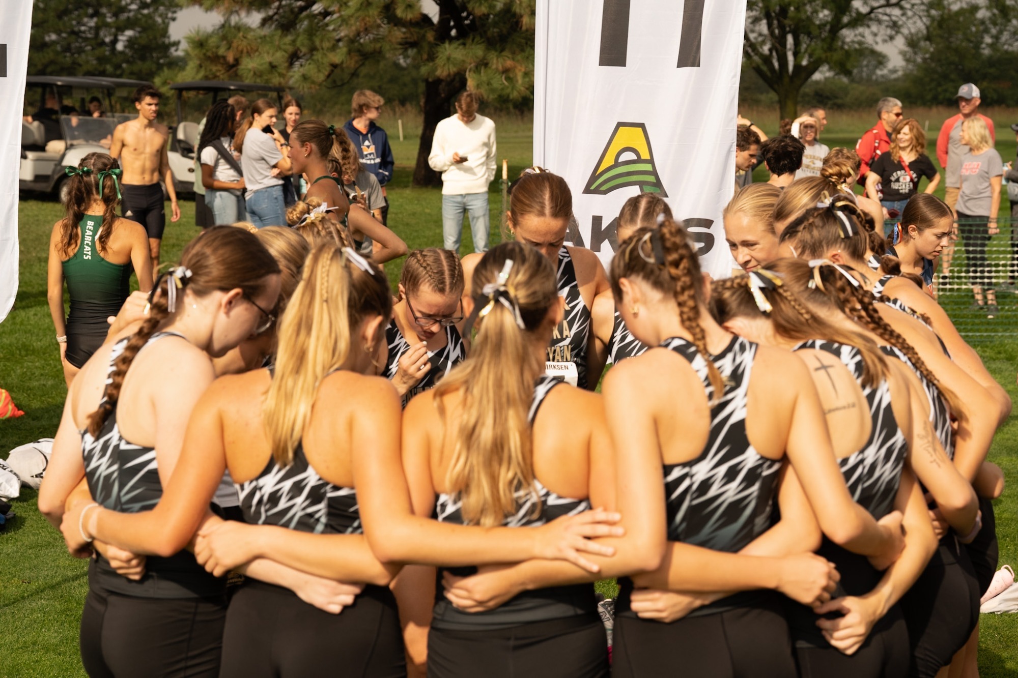 Women's cross-country teams gets ready for a race.  