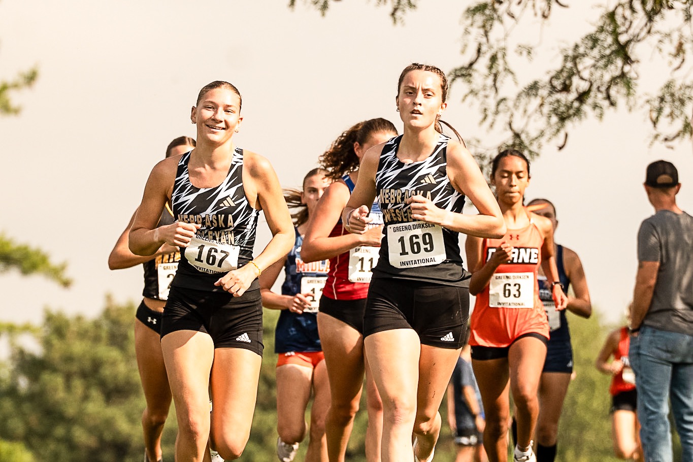 Lauren Maw & Alexis O'Connell run together smiling at the Greeno-Dirksen Invite