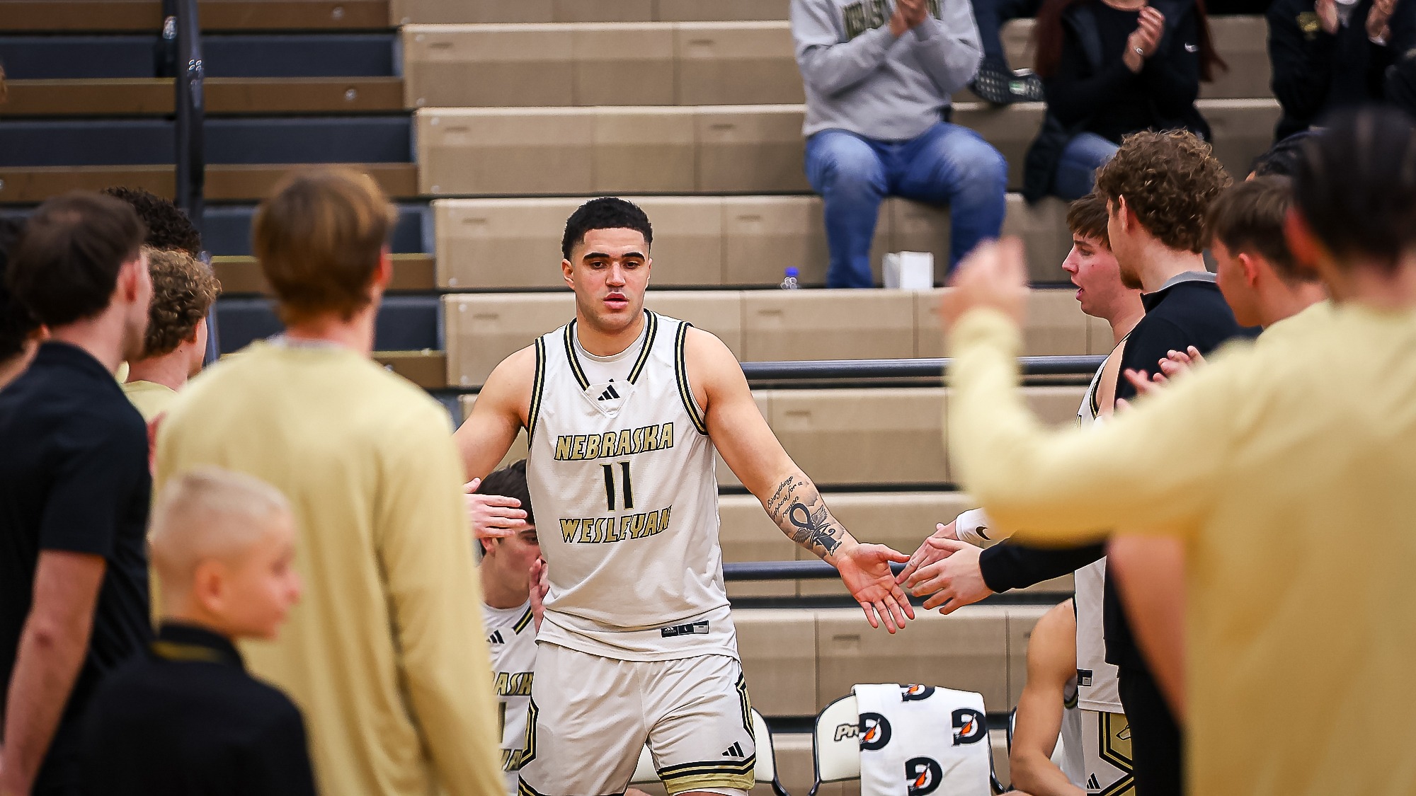 Amun-Ra Collins goes through the line of high fives after being announced as a starter.