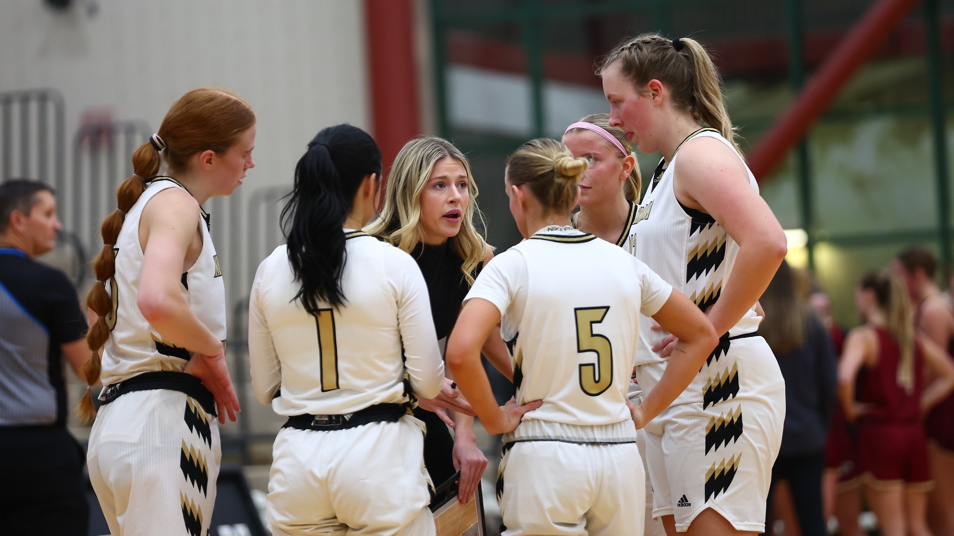 Coach Sydney Golladay speaks to the starters pregame