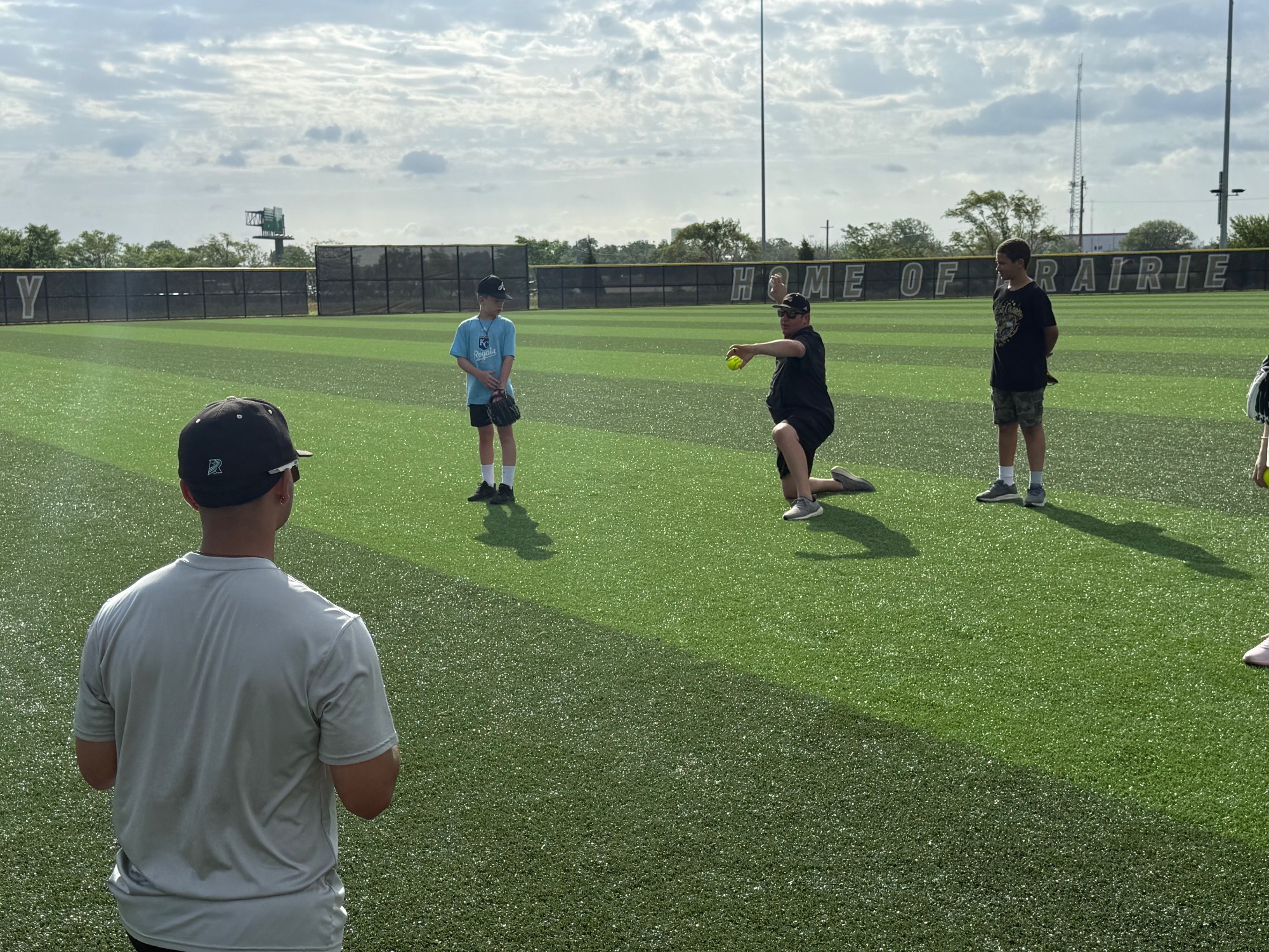 Jeff Christy gives instructions on how to throw a baseball to campers from Lincoln Community Learning Centers