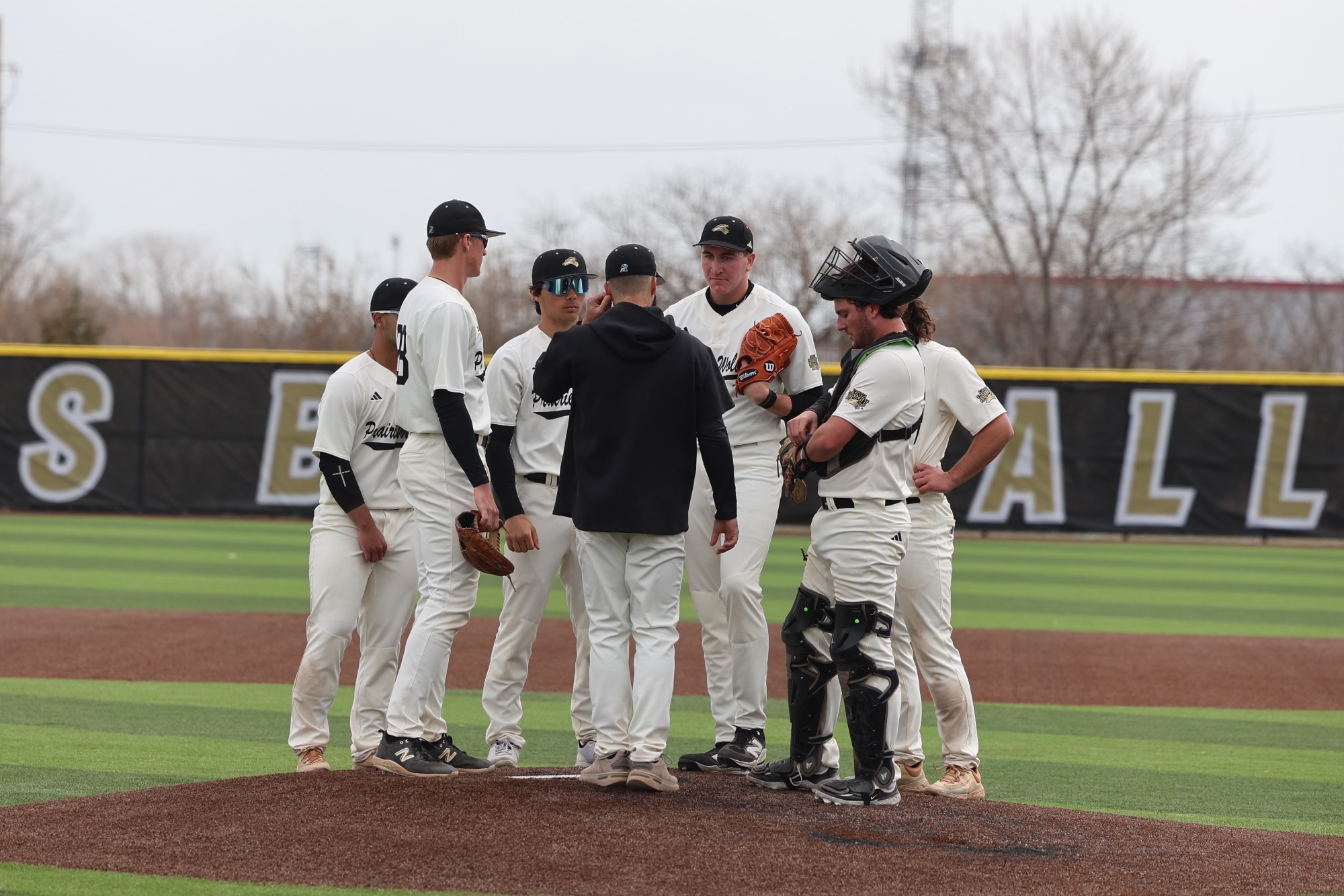 Assistant Coach Josh Roder visits with the team on the mound.