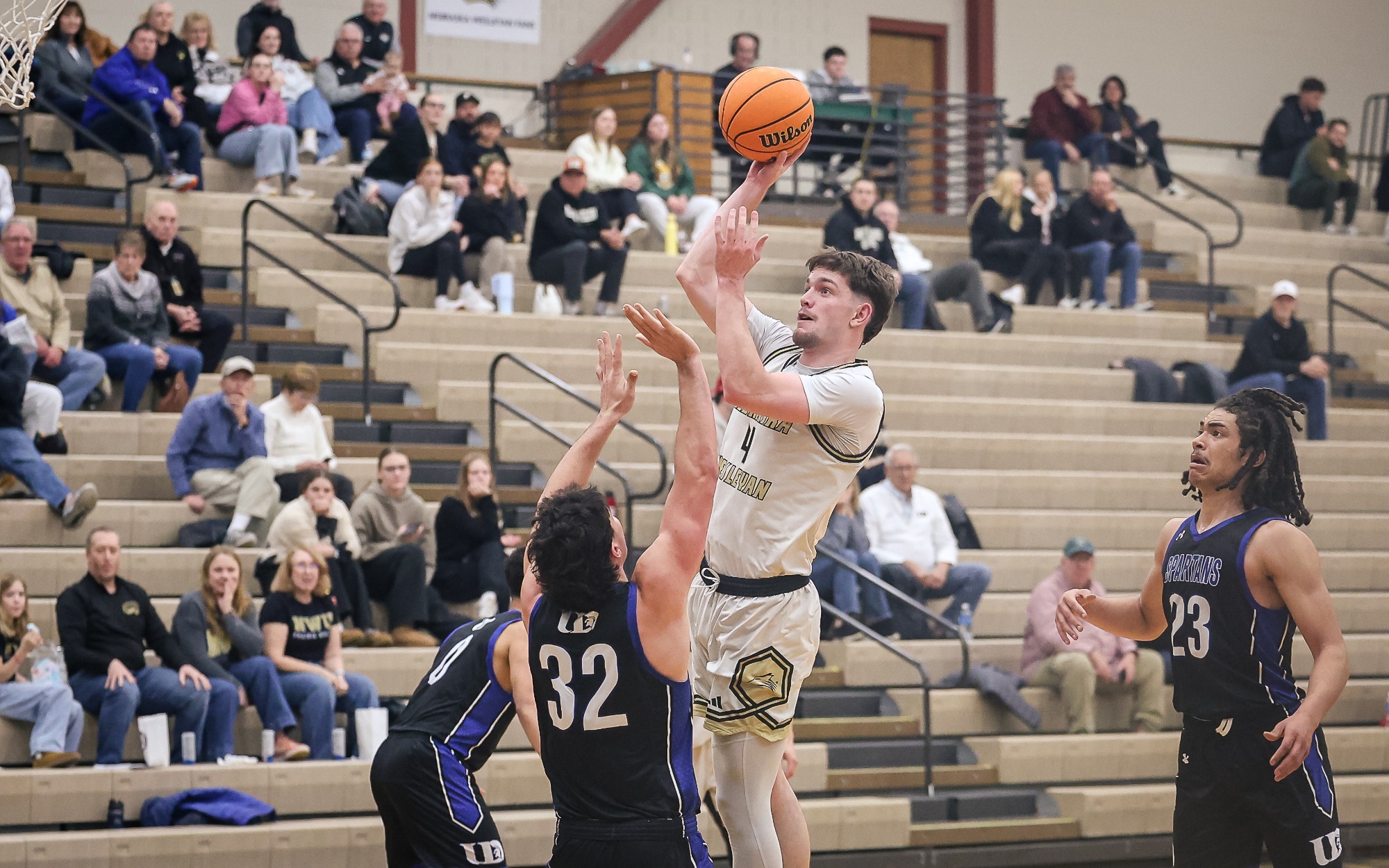 Seth Newton shoots a hook shot over a Dubuque defender