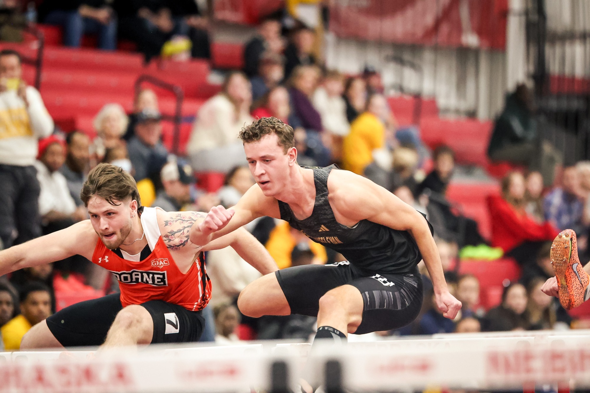 Connor Plahn runs over a hurdle