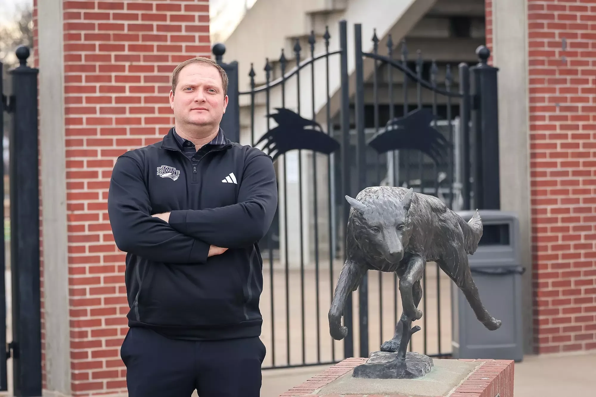  Jacob Donohoe stands next to the Prairie Wolf statue outside of Abel Stadium