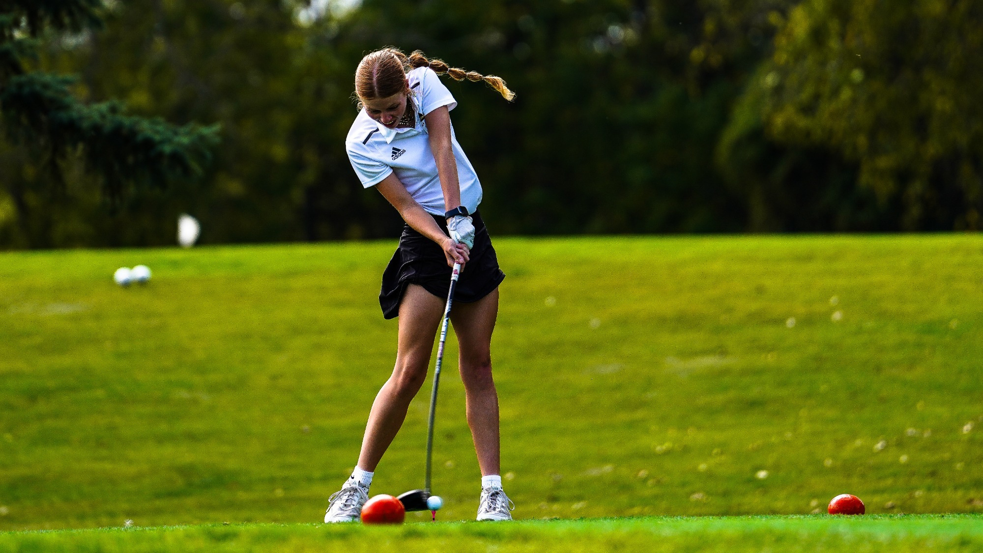 Lauren Hays drives a ball off the tee