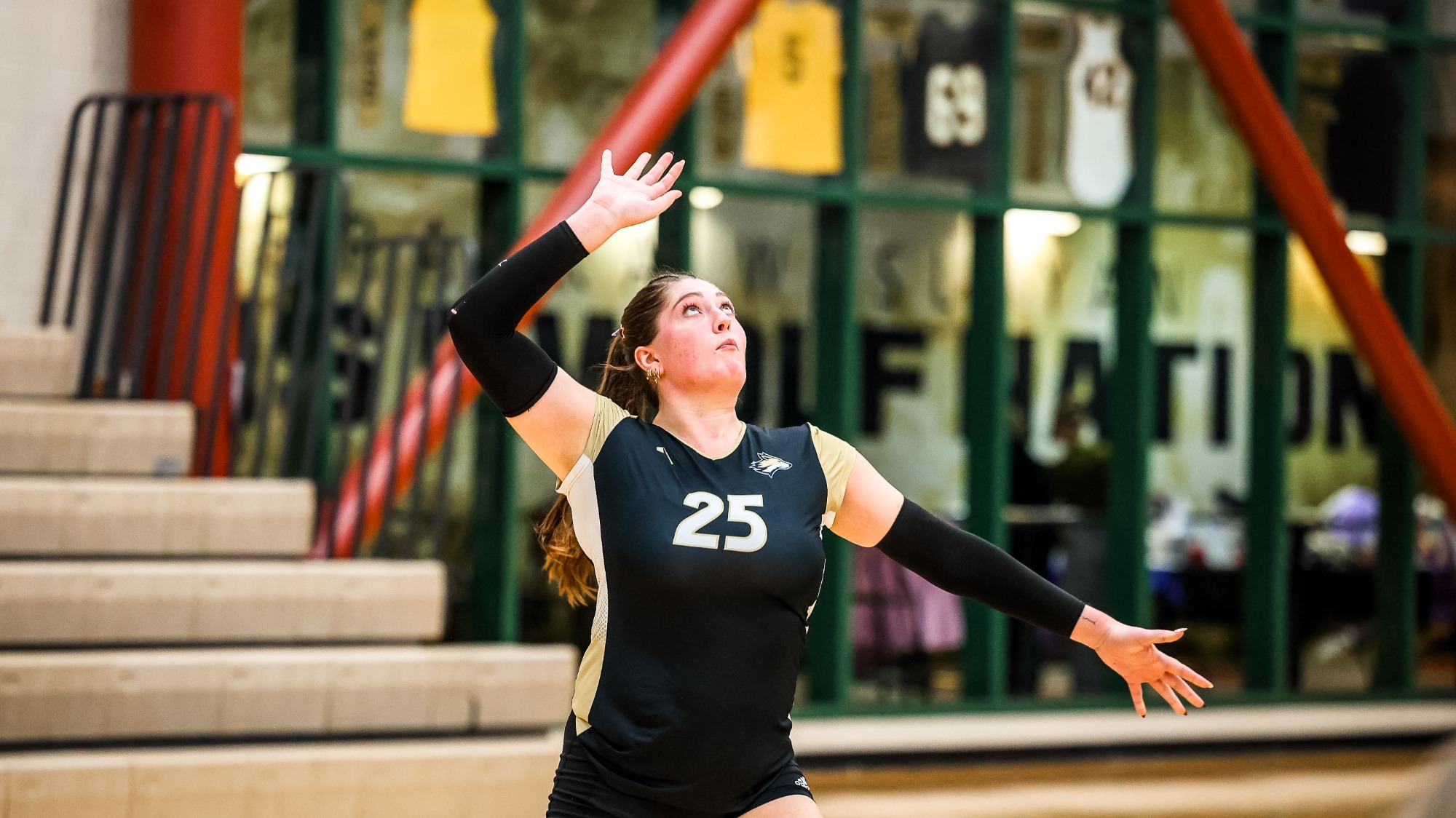 Molly Ramirez tosses the ball up for a serve