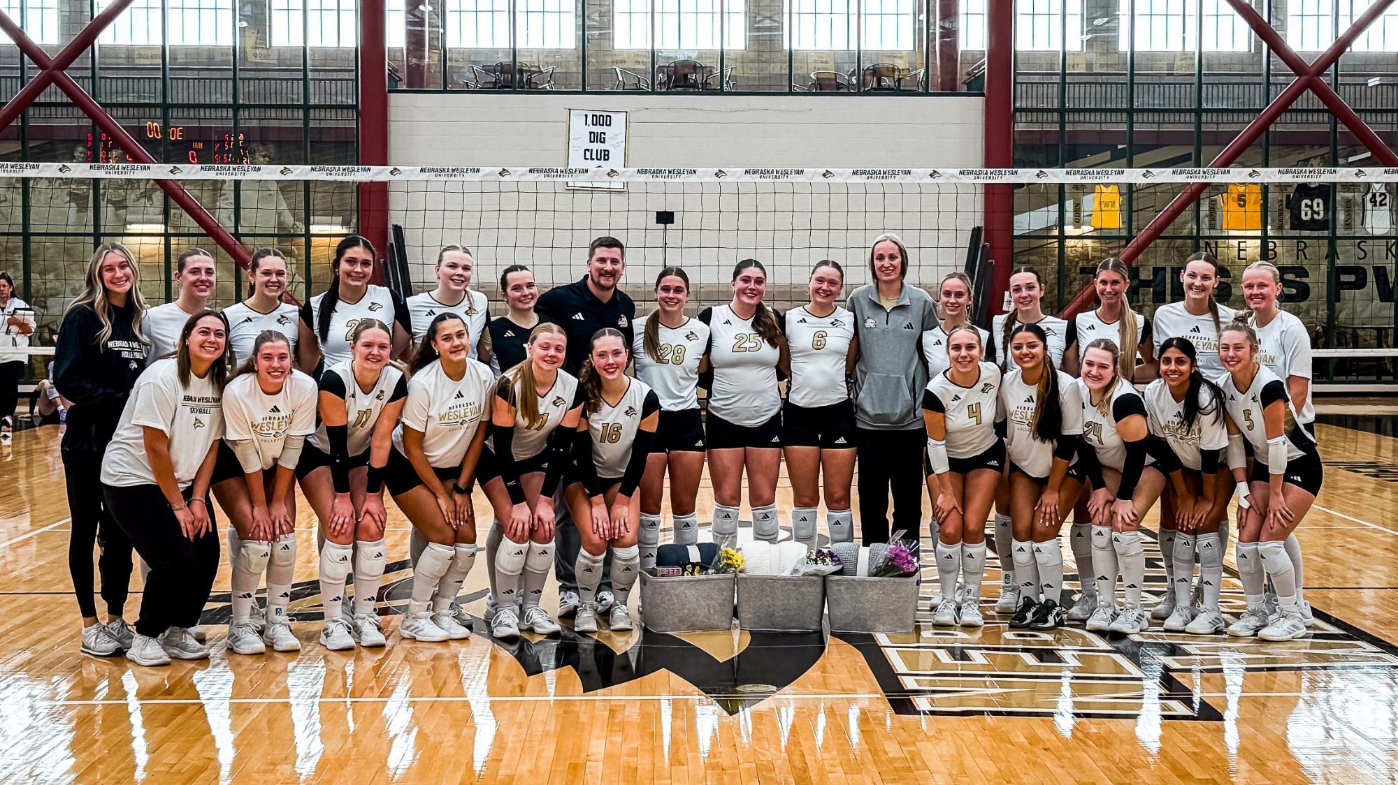 Volleyball team photo poses with the senior class on senior day