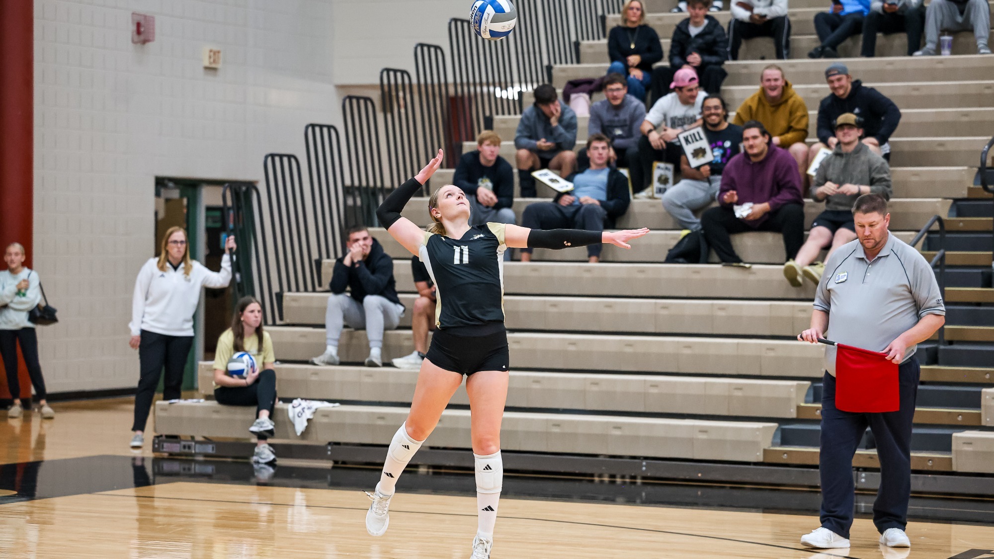 Macy Plucker tosses the ball up to serve