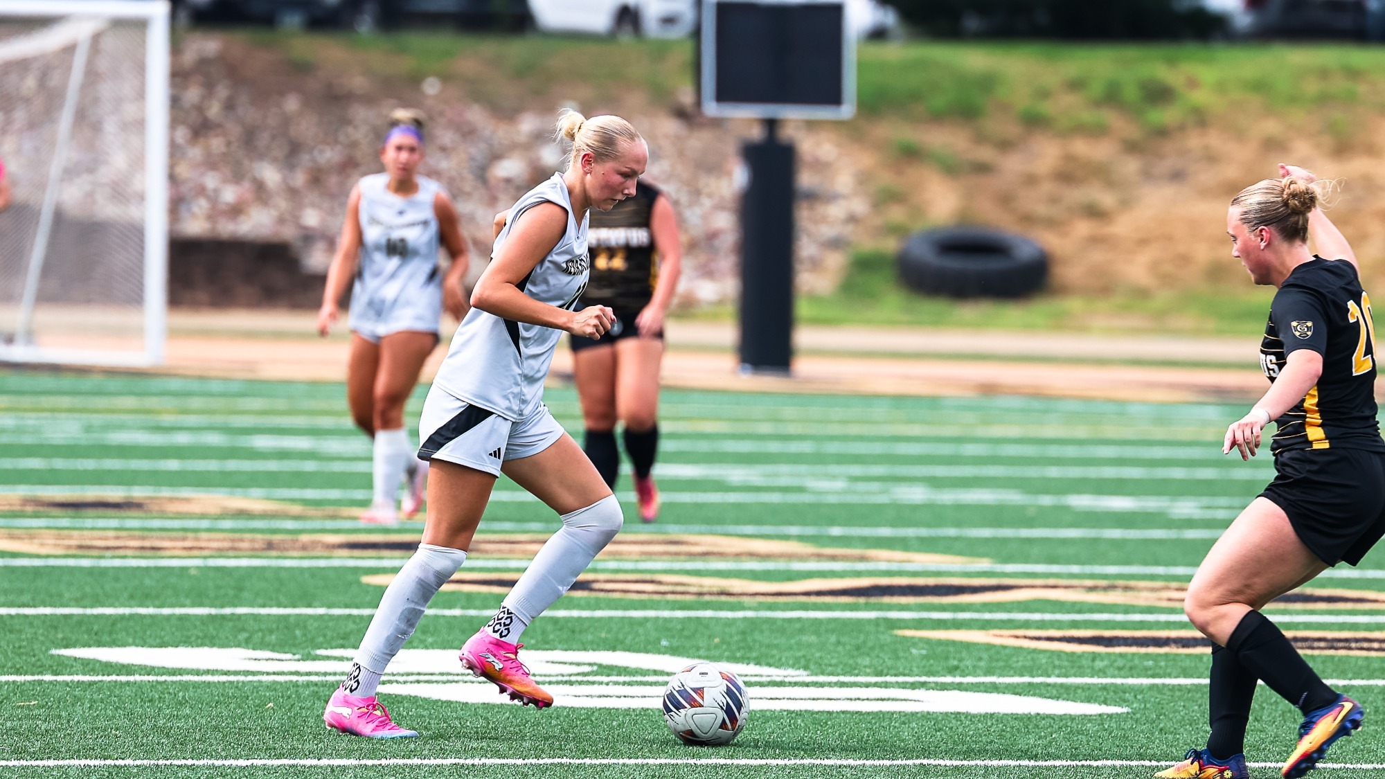 Berlyn Parker dribbles a ball past a Gustavus defender