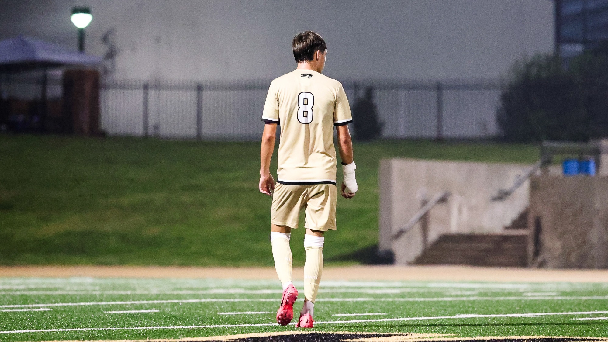 Connor Currence walks on the soccer pitch