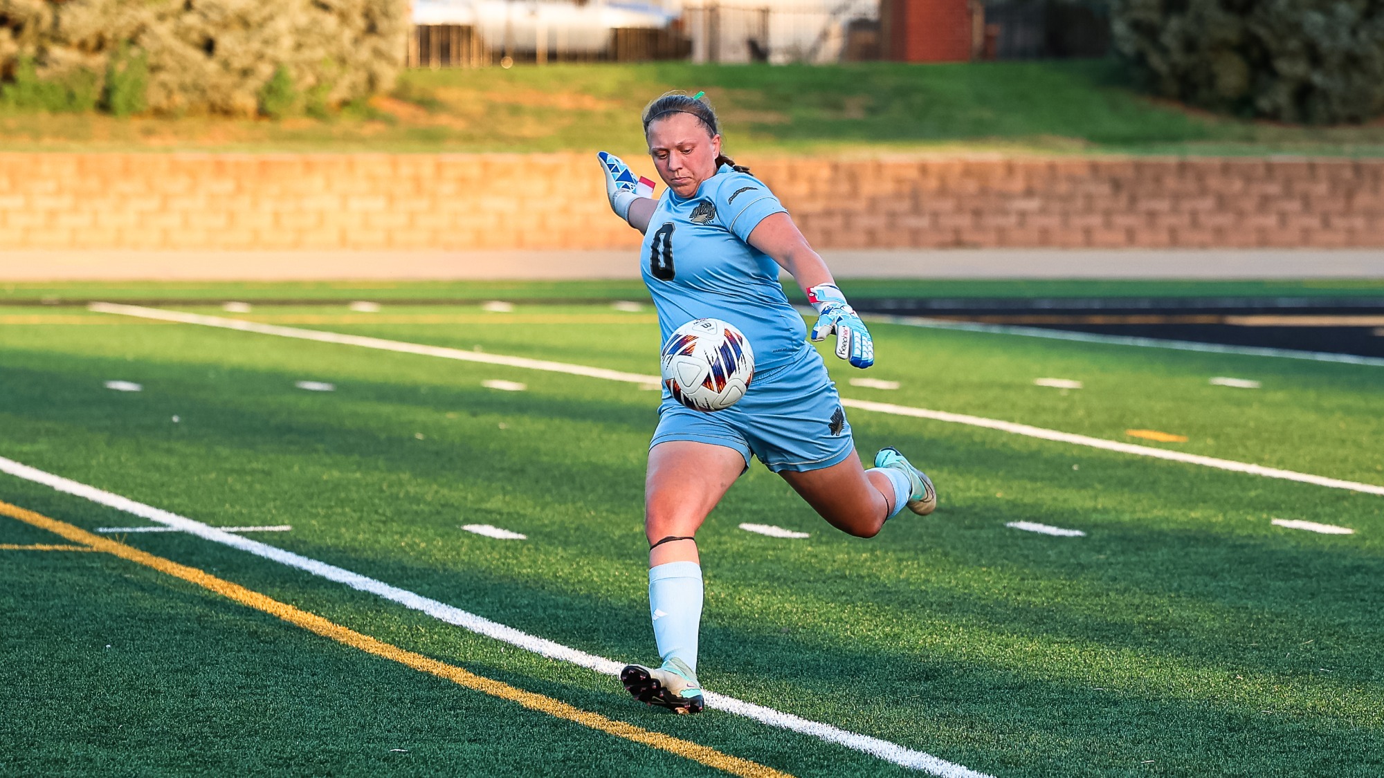 Amber Pyle dropkicks a ball down field from the goalie box