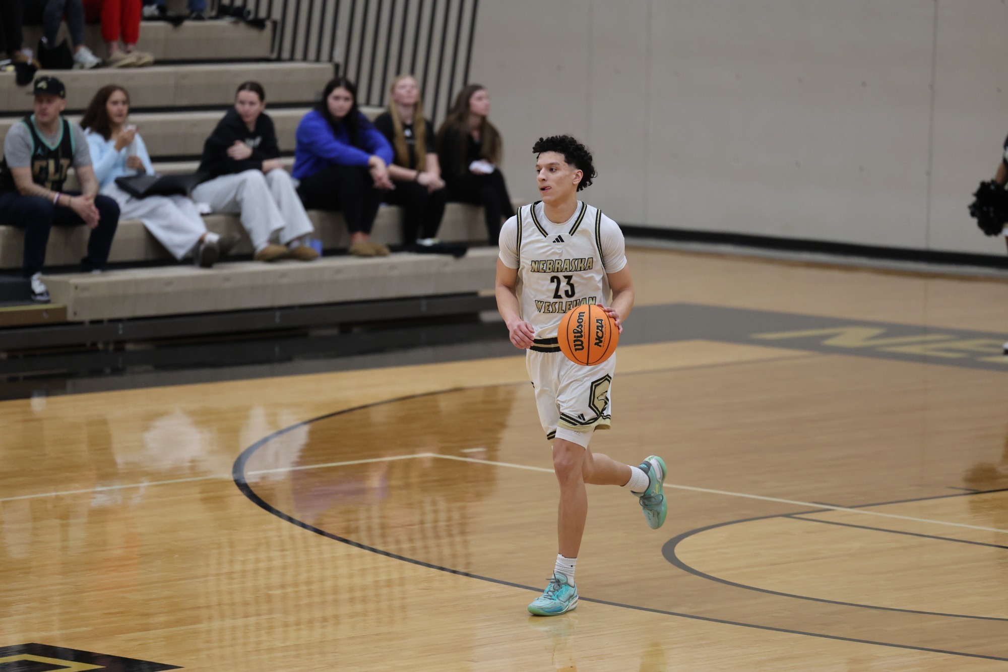 Christian Winn dribbles up the court against Wartburg