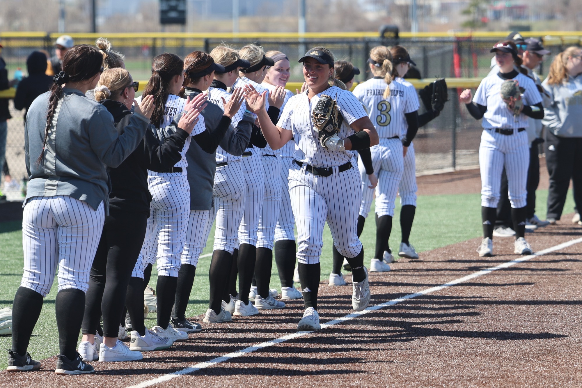 Jenna Kimberling high fives through the lineup