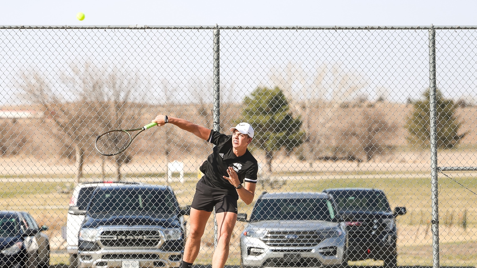 Gavin Nichols fires a serve across the net