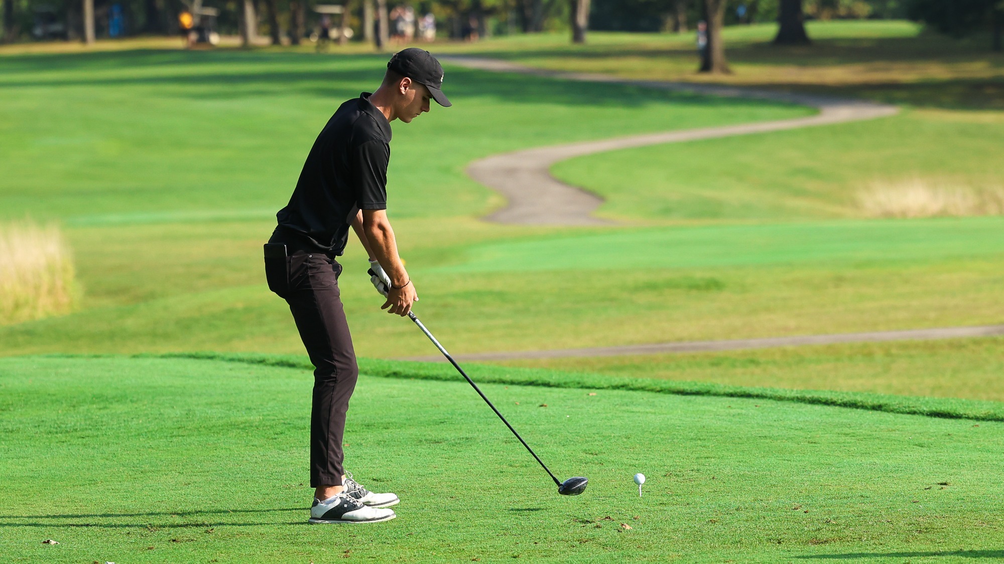 BRAYDEN SCHRAM lines up to the ball on the opening teebox