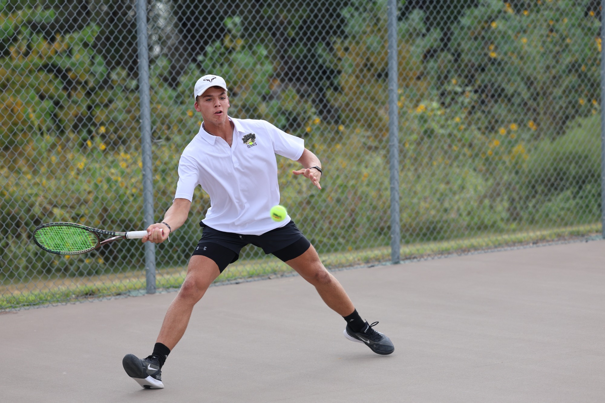 Gavin Nichols returns a serve against Concordia
