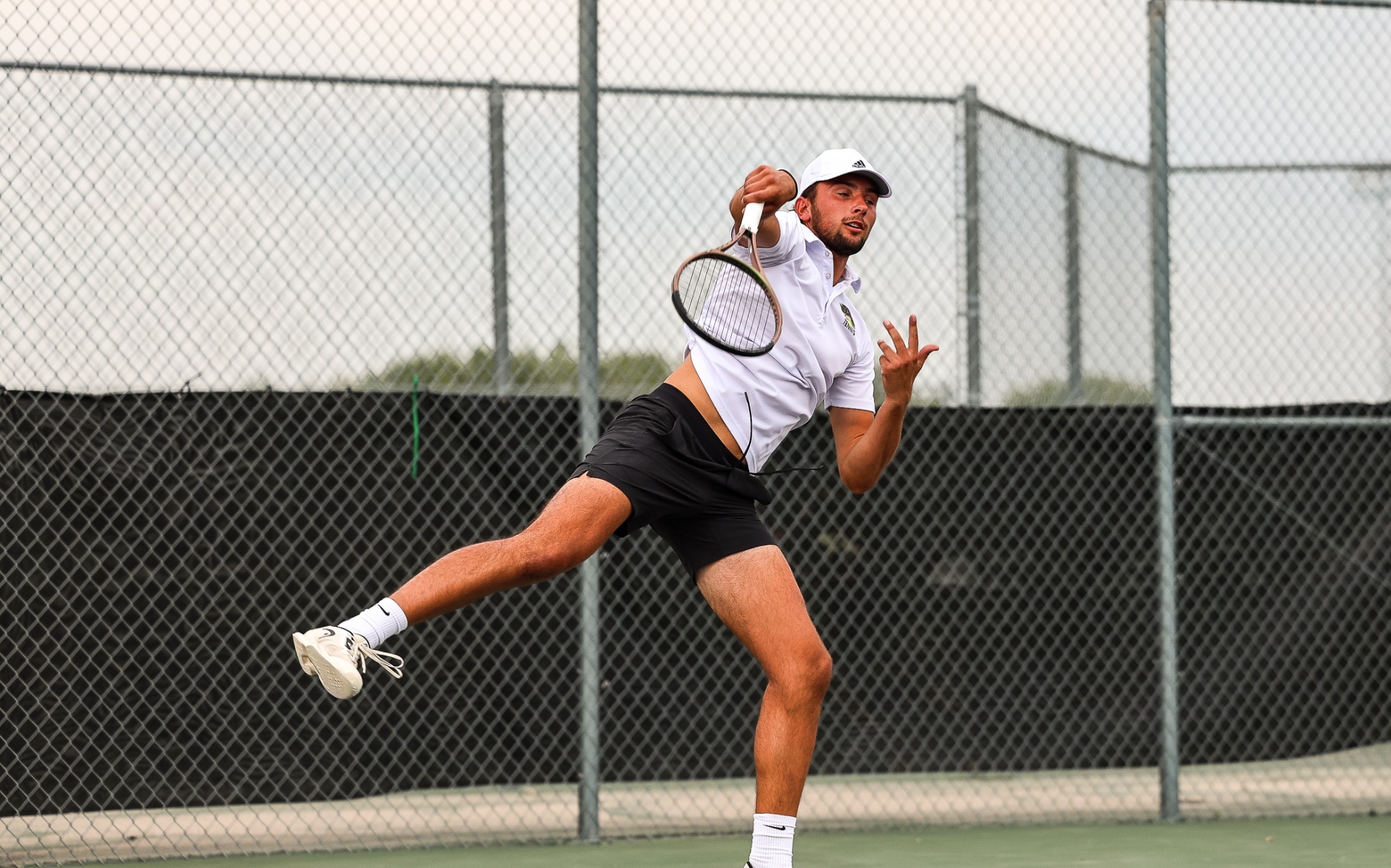 Ian Armbrust delivers a powerful serve