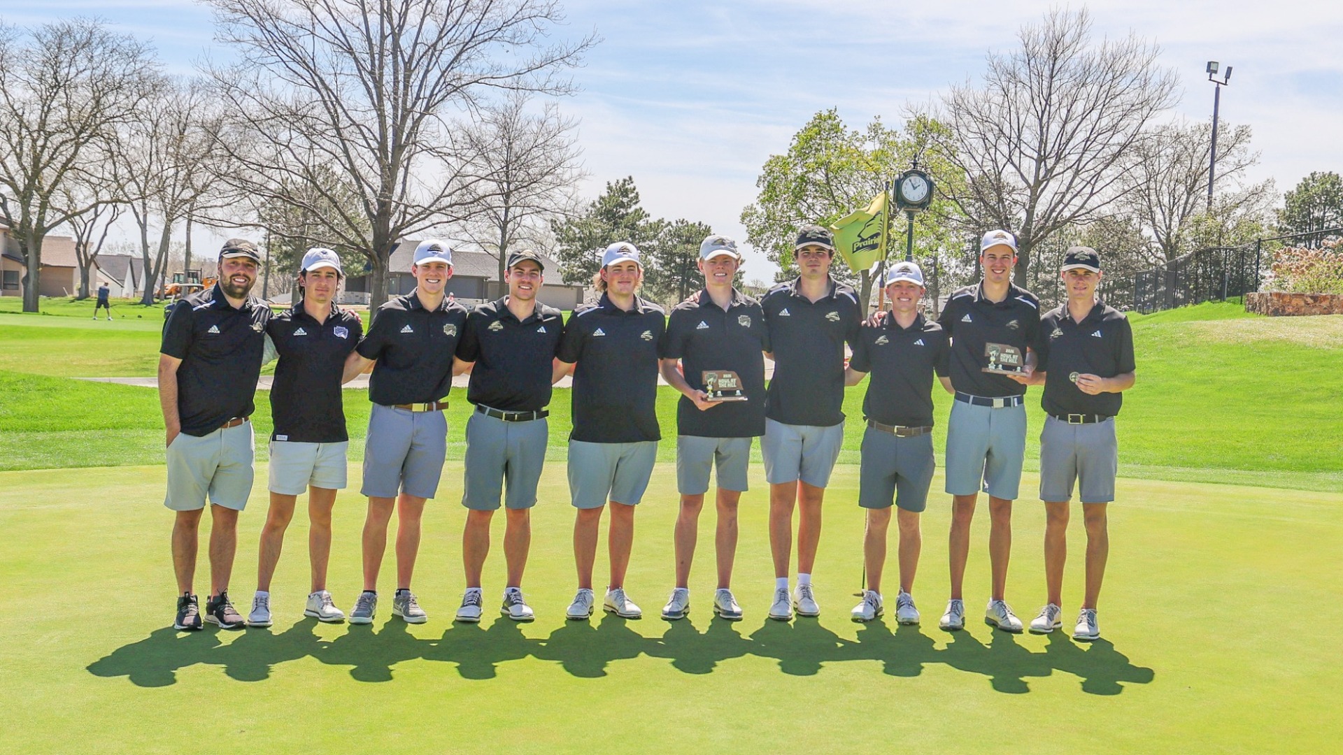 Men's Golf Team poses with their Championship Trophy at our home Howl at the Hill Invitational